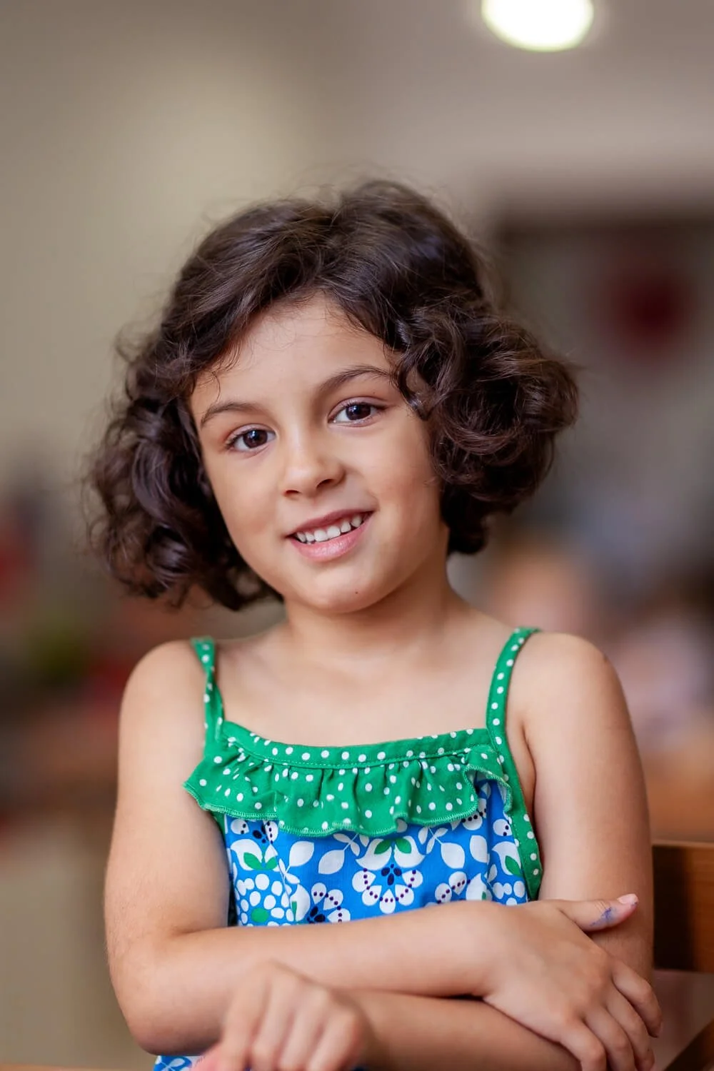 Natural, unposed moment of a girl during quiet time in a Hong Kong Montessori preschool environment.