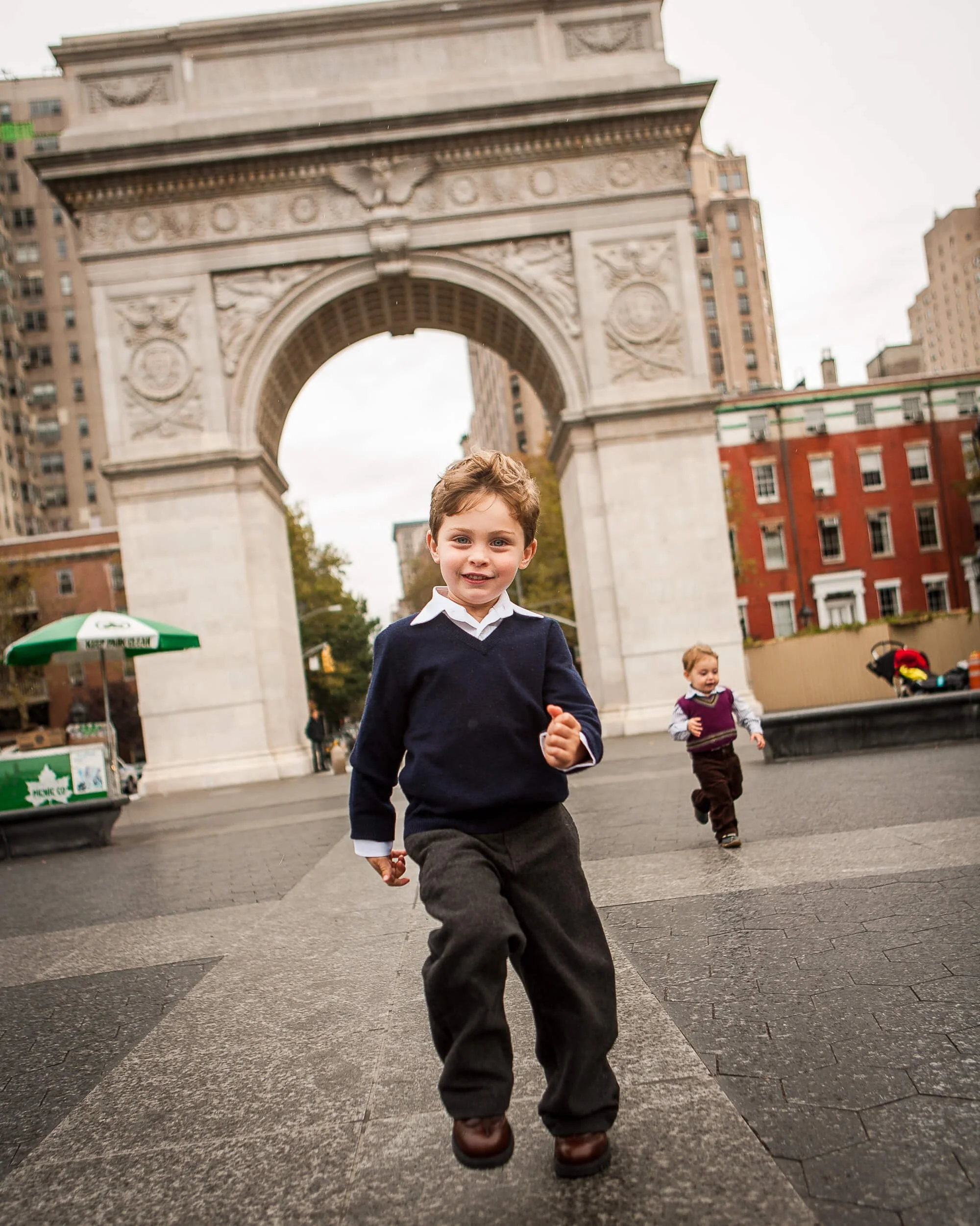 A boy runs in Washington Square in New York City