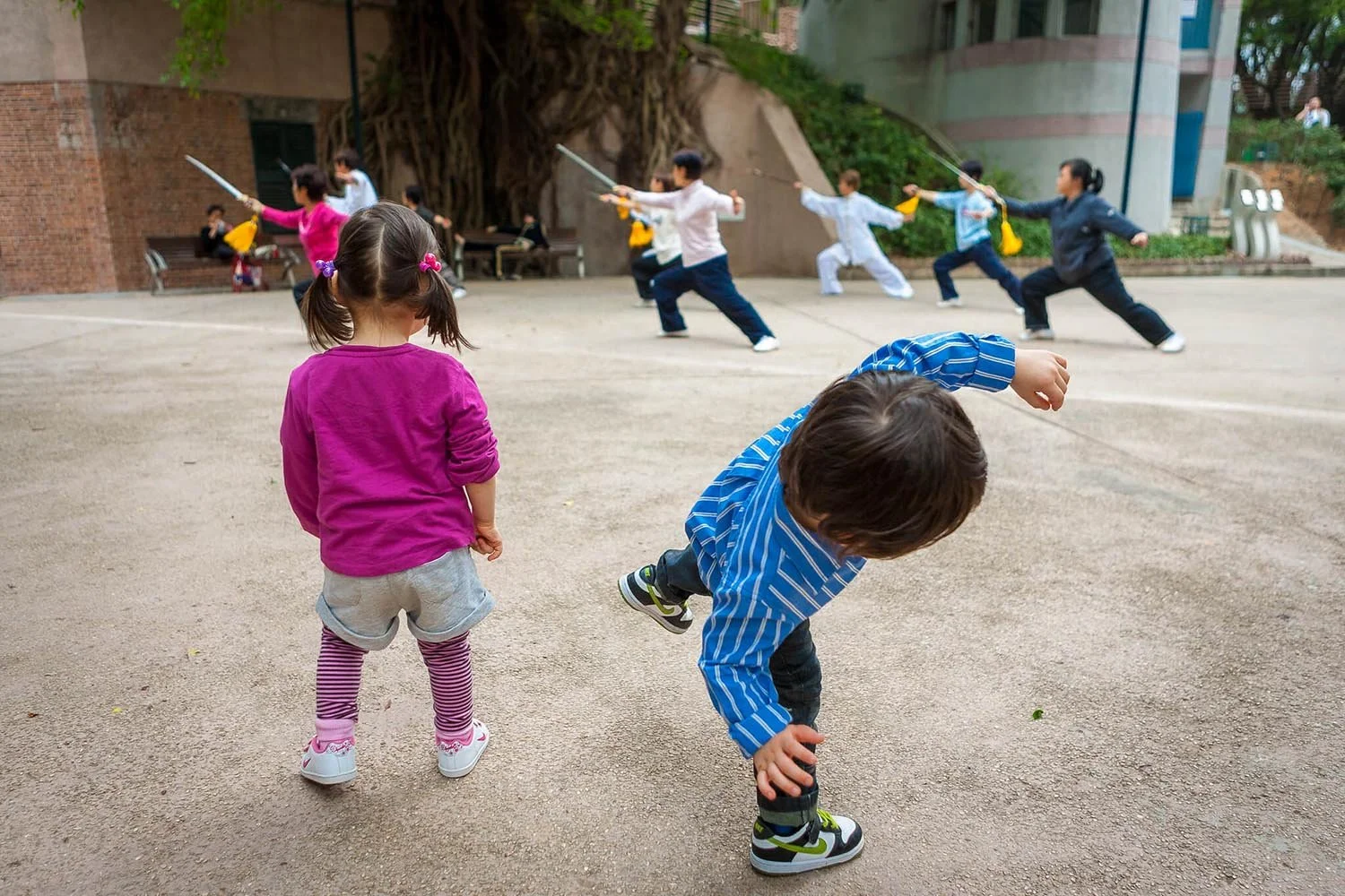 Twins watch sword practice at Kowloon Park Hong Kong