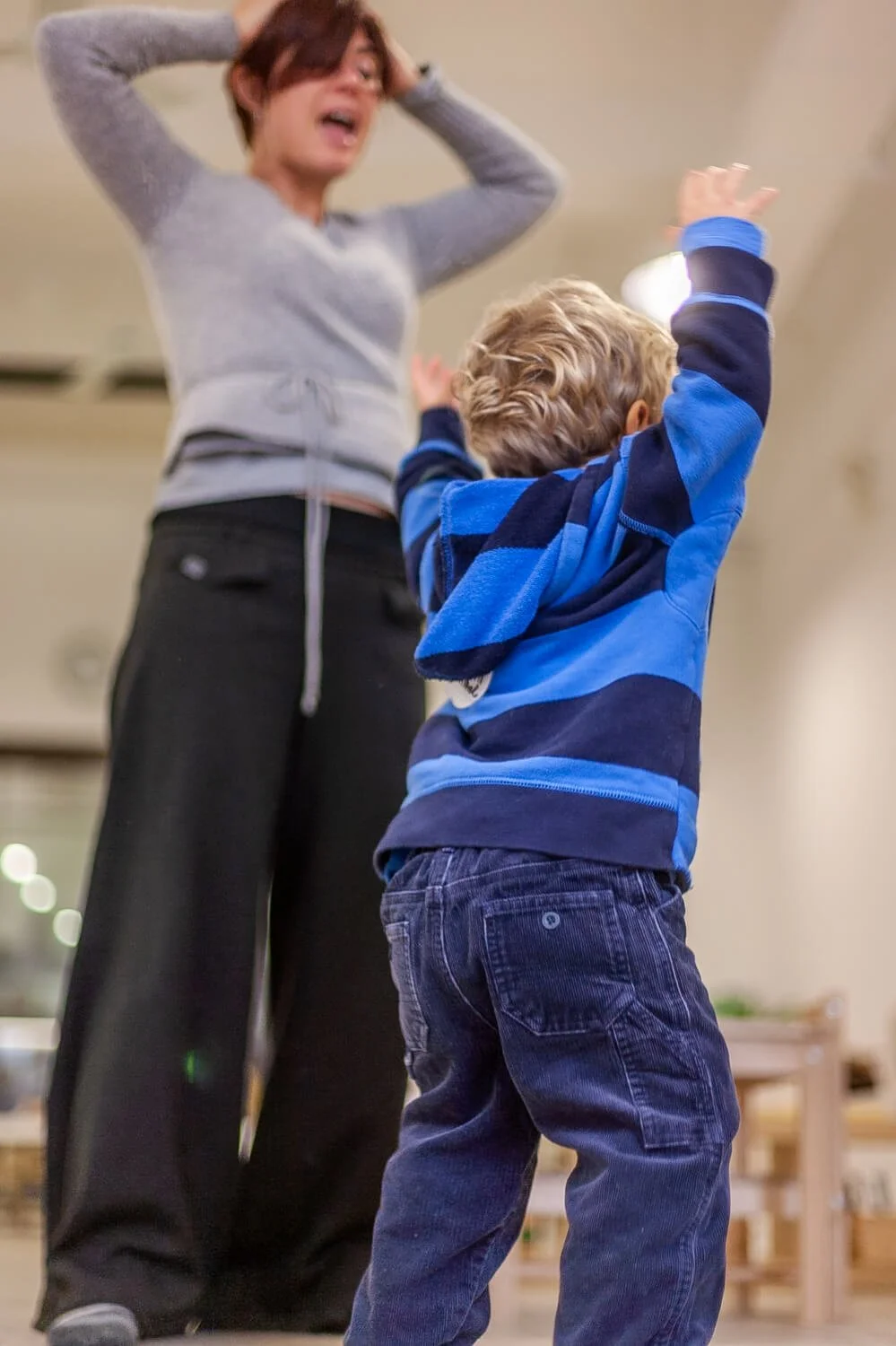 Boy dances with his mom at a Montessori school in HK