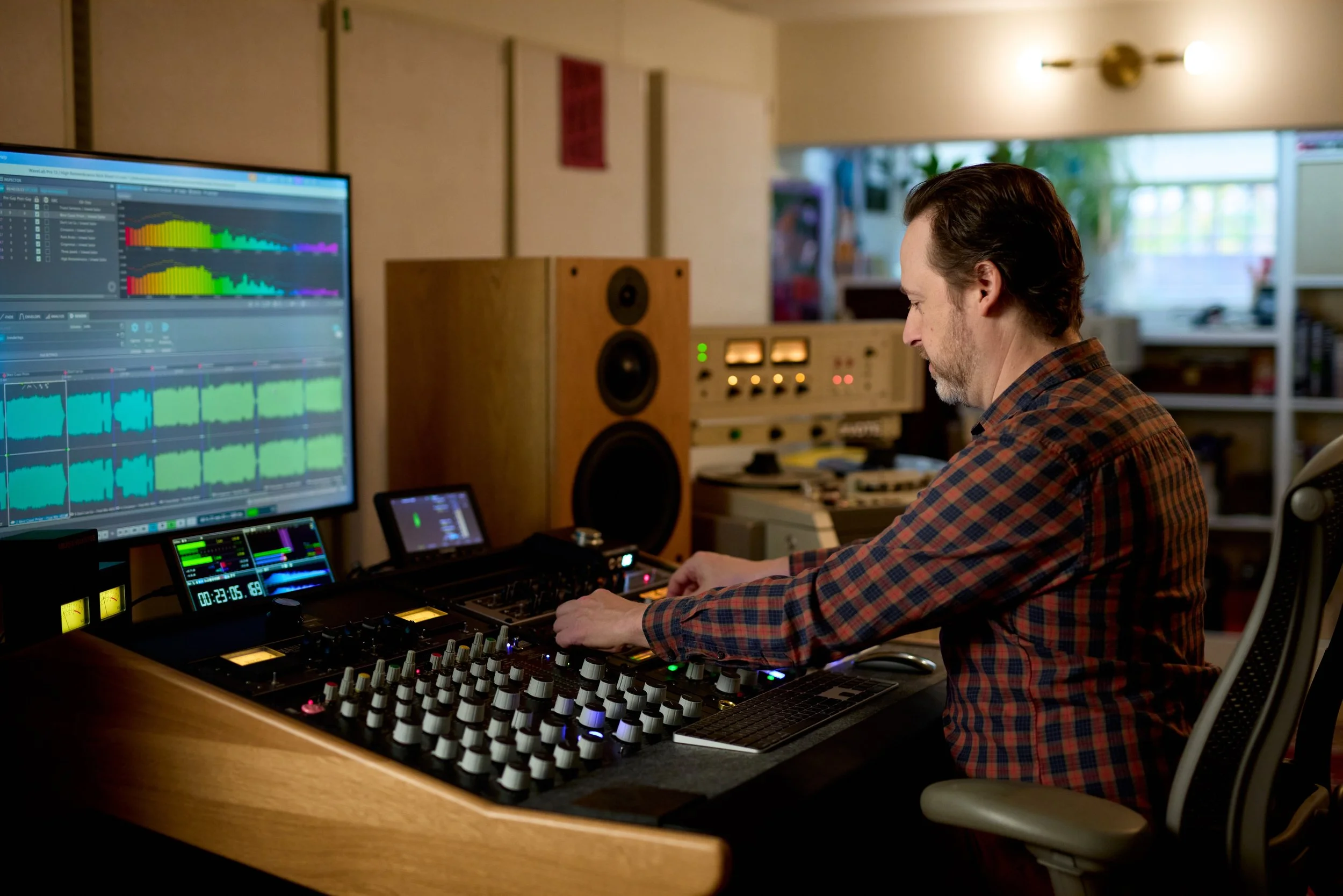 Mat Leffler-Schulman. a mastering engineer,  at his mastering desk / studio in front of the WaveLab Pro DAW on the screen.