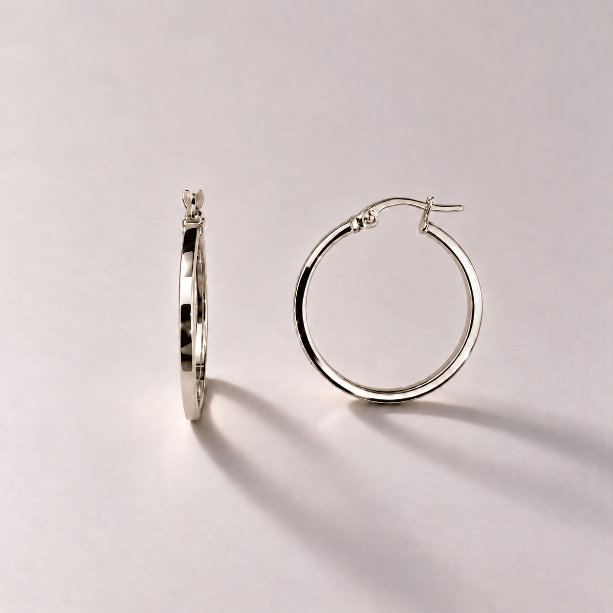 Polished white gold hoop earrings (3).png