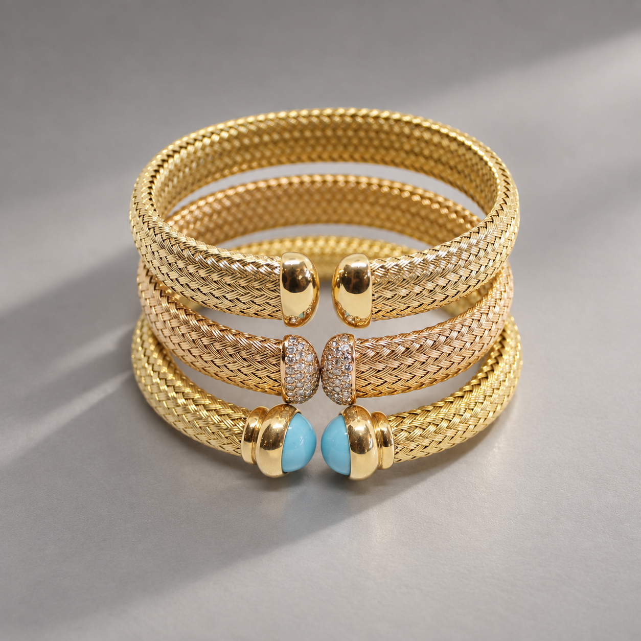Three stacks of gold and rose gold bracelets with different textured bands, featuring various decorative elements including turquoise stones, diamonds, and plain gold accents.
