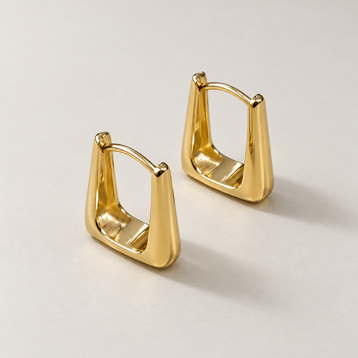 Polished tapered yellow gold hoop earrings-1.png