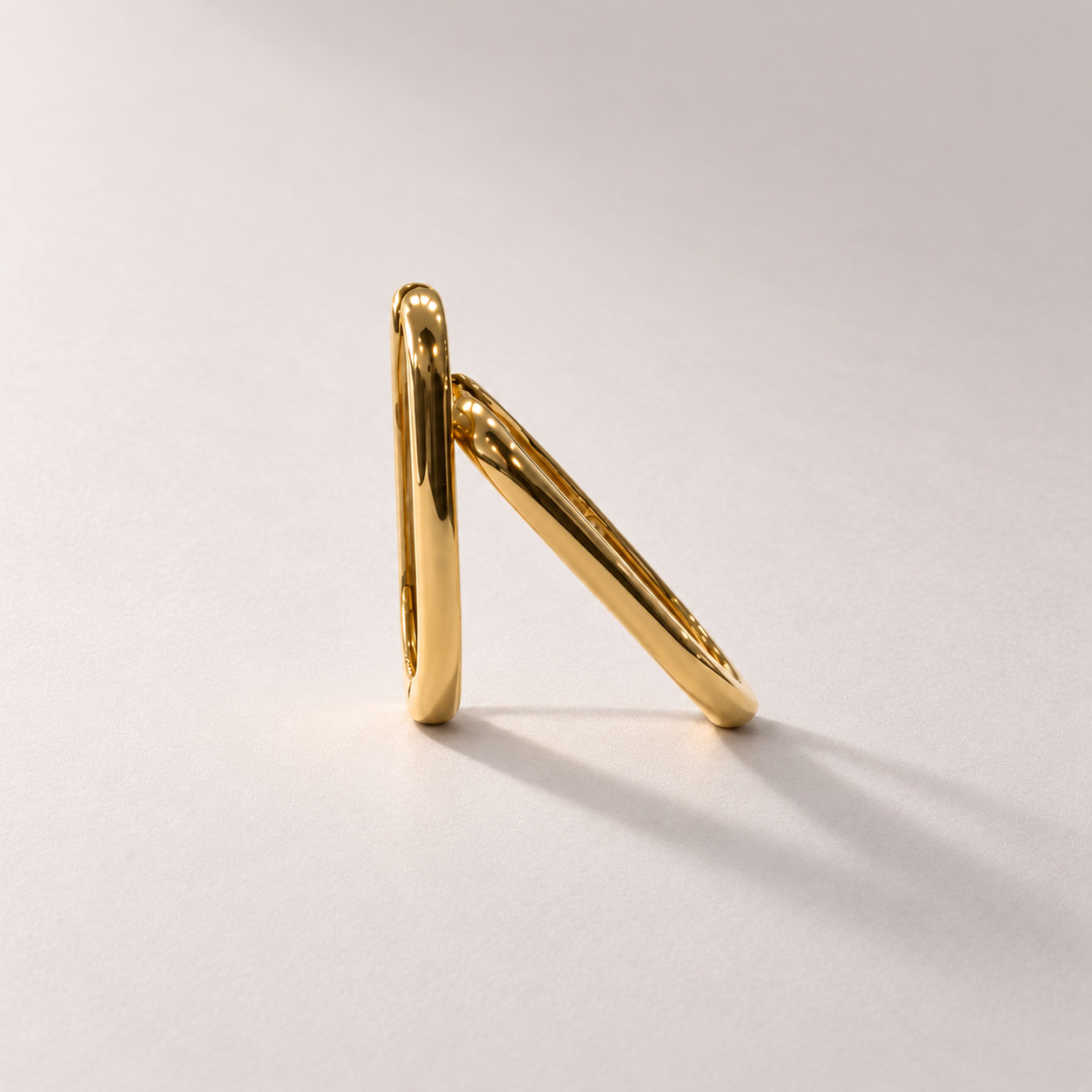 Luxury gold hoops on warm grey.png