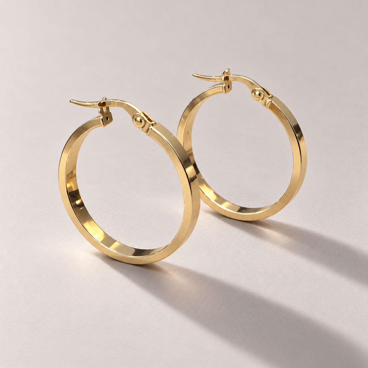 Polished yellow gold hoop earrings-1.png