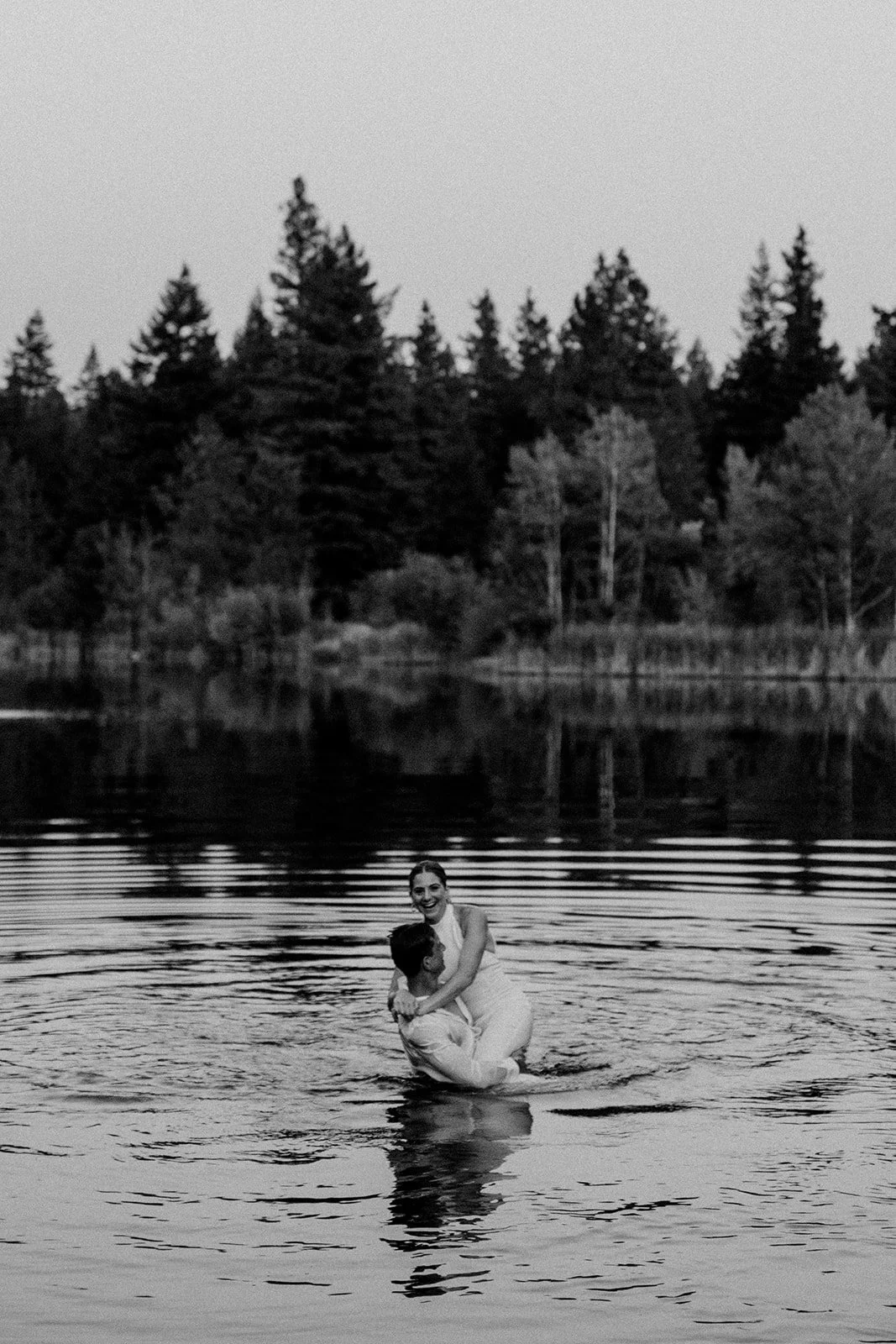 Bride and groom go for a dip in the lake after their Washington wedding in the mountains