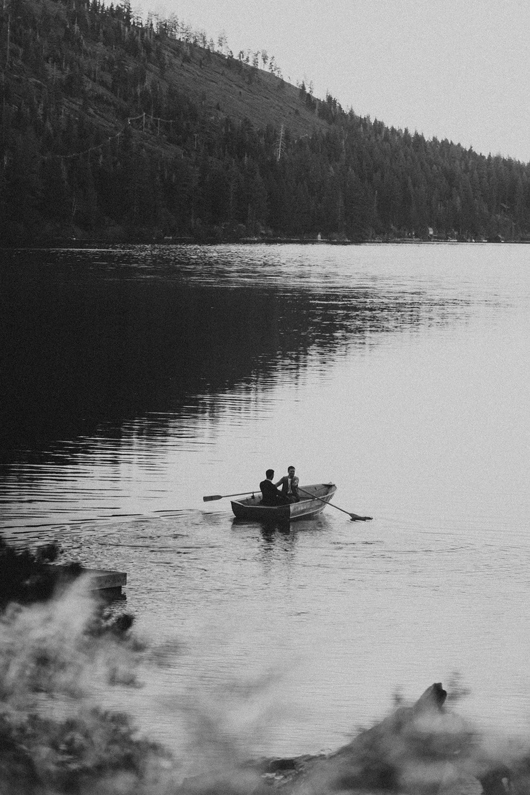 Groom's take portraits in a small boat on Lake Tahoe
