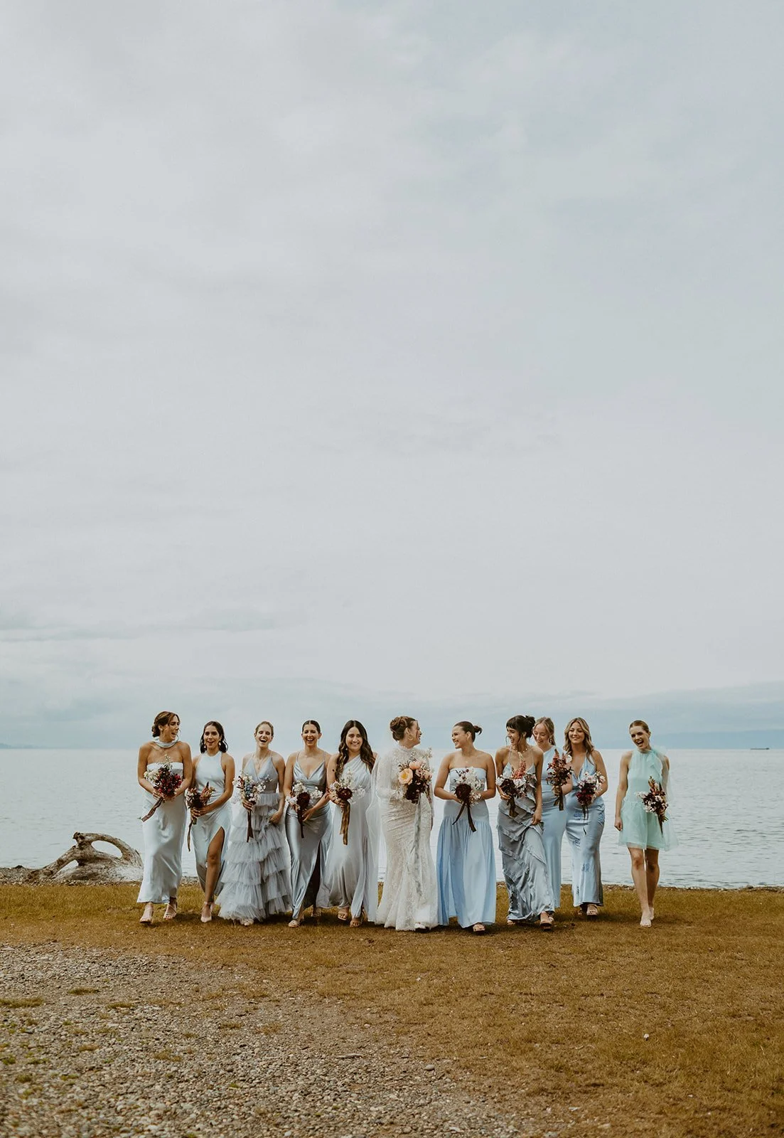 Bride walks with her bridesmaids on the shore near Orcas Island