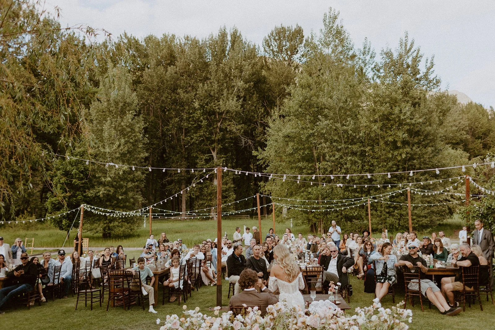Bride and groom give a speech during their outdoor wedding reception in Washington State