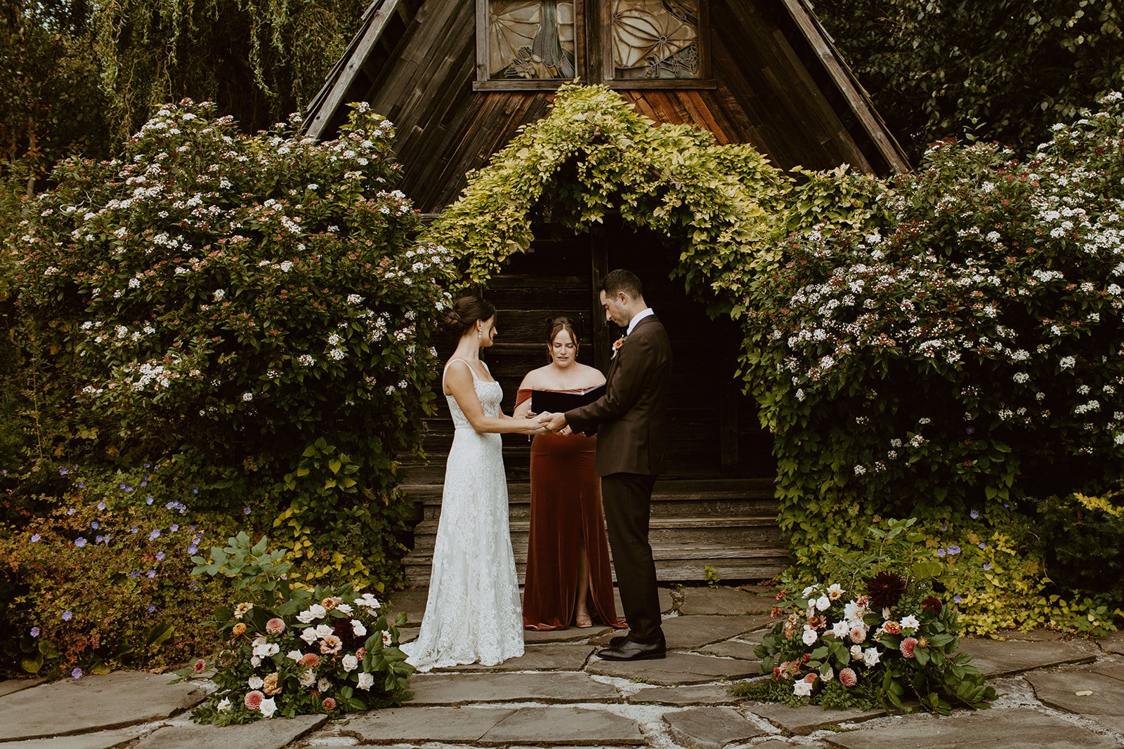 Fall wedding ceremony on Orcas Island with think greenery surrounding the altar space
