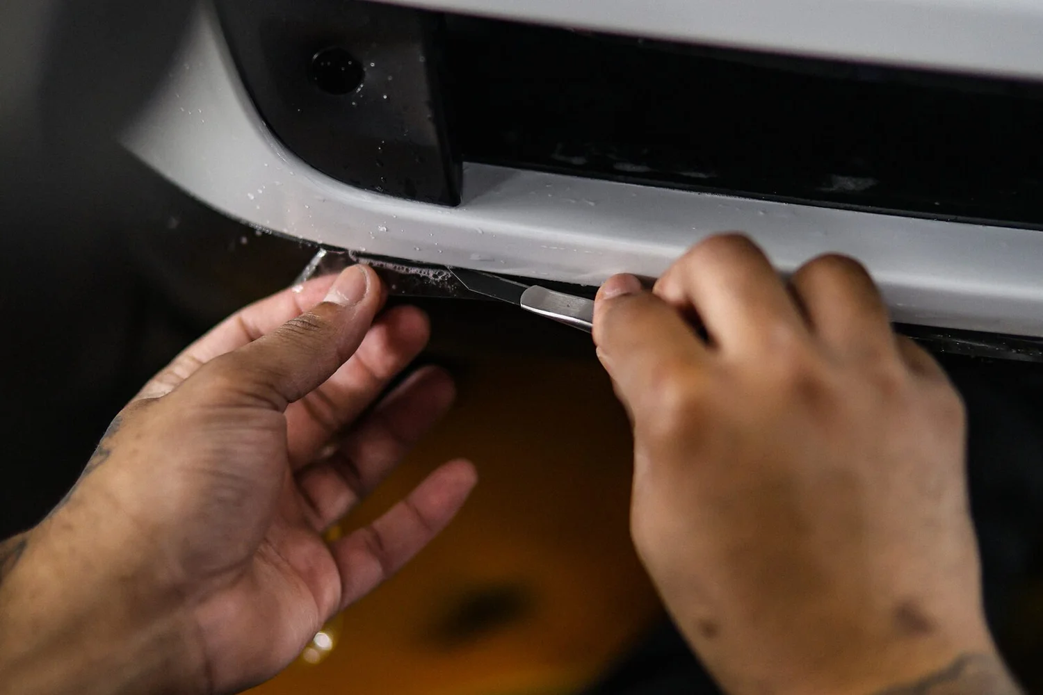 Paint protection film being installed by hand