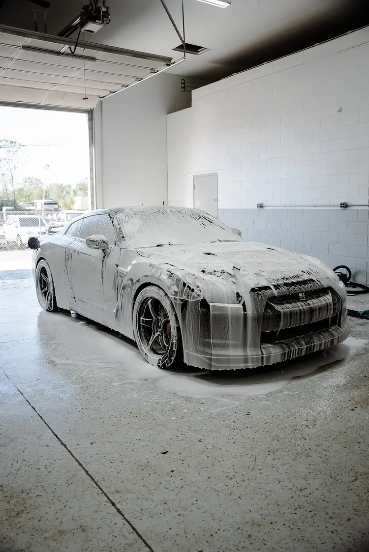 Nissan GT-R covered in foam in the detailing bay at Ascension Automotive