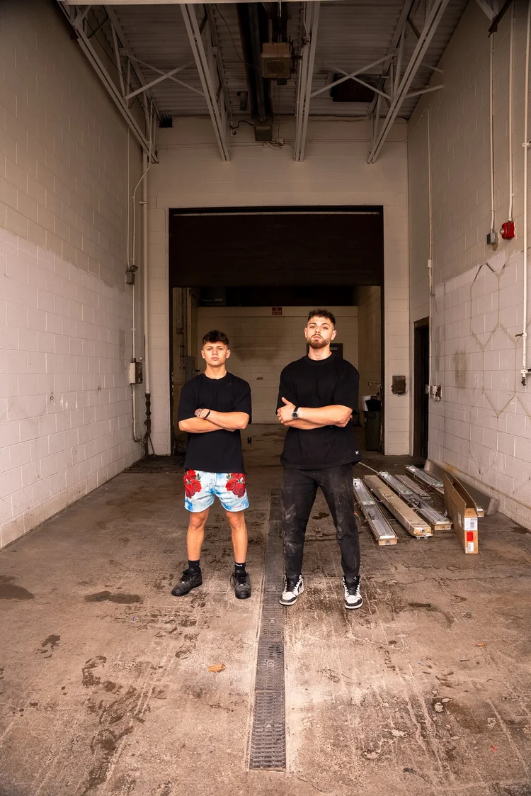 David and Elias Alam standing inside the empty brick warehouse where Ascension Automotive began