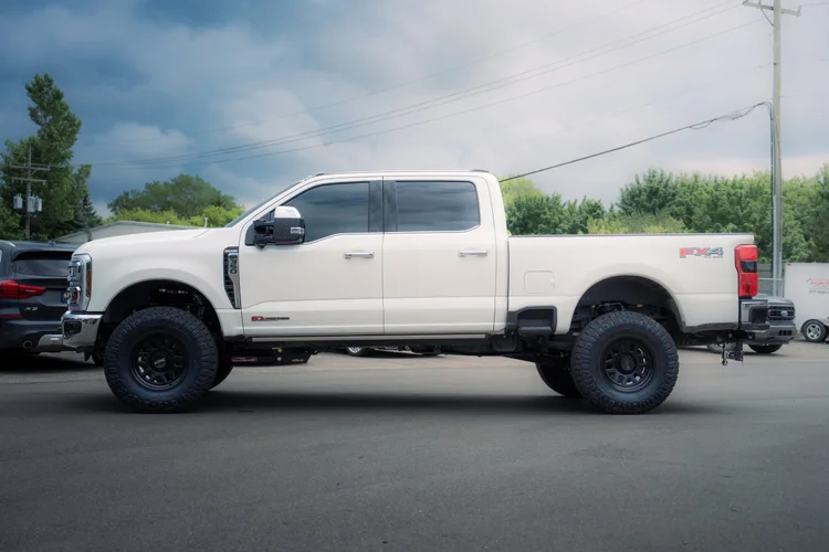 White Ford Super Duty side profile with ceramic window tint at Ascension Automotive