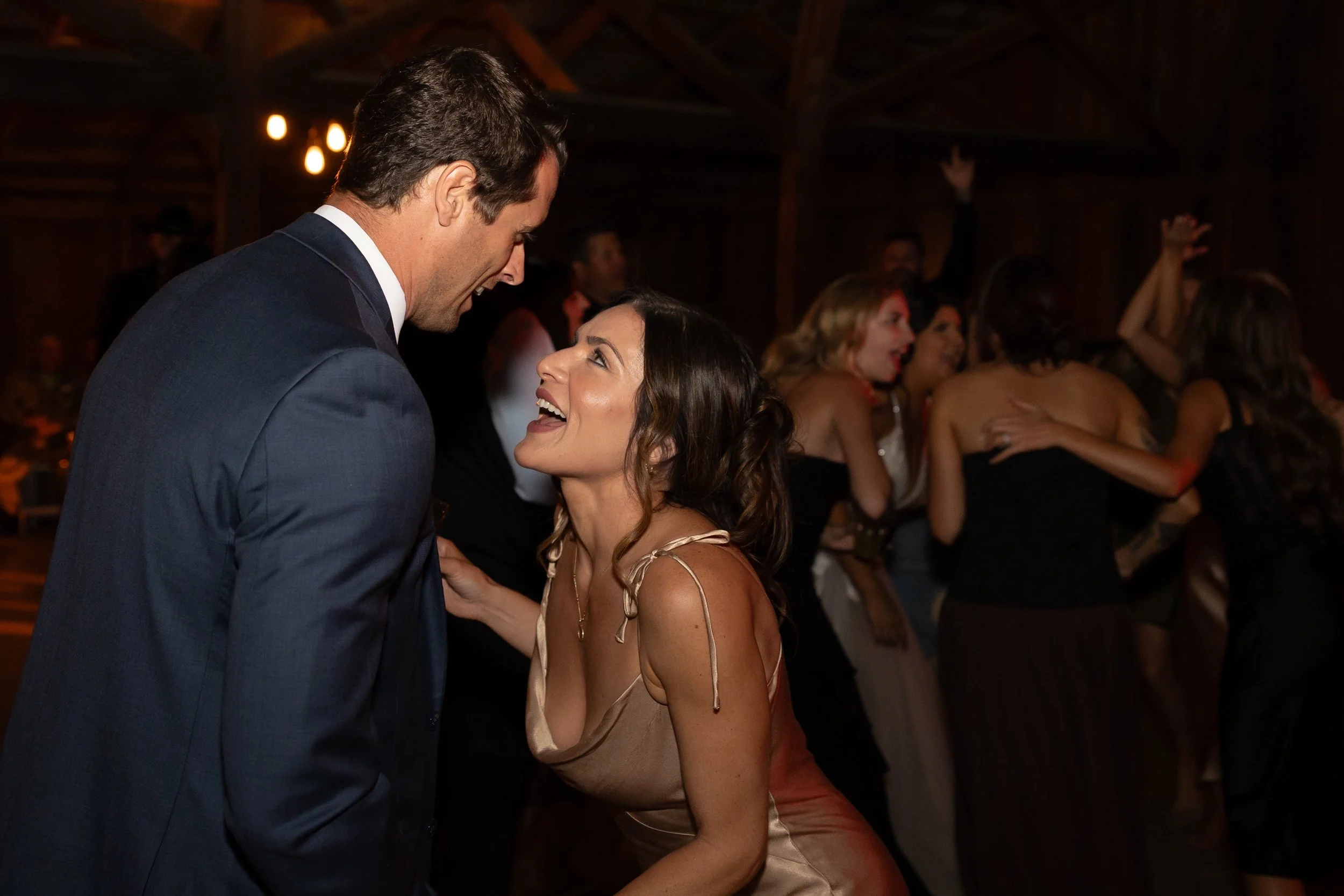 Photo Credit: J Leigh Photography, Tar Creek Ranch, Arroyo Grande Wedding (A young couple enjoys a dance together. In the background the bride and her friends can also be seen. Everyone is having a great time on the dance floor!)