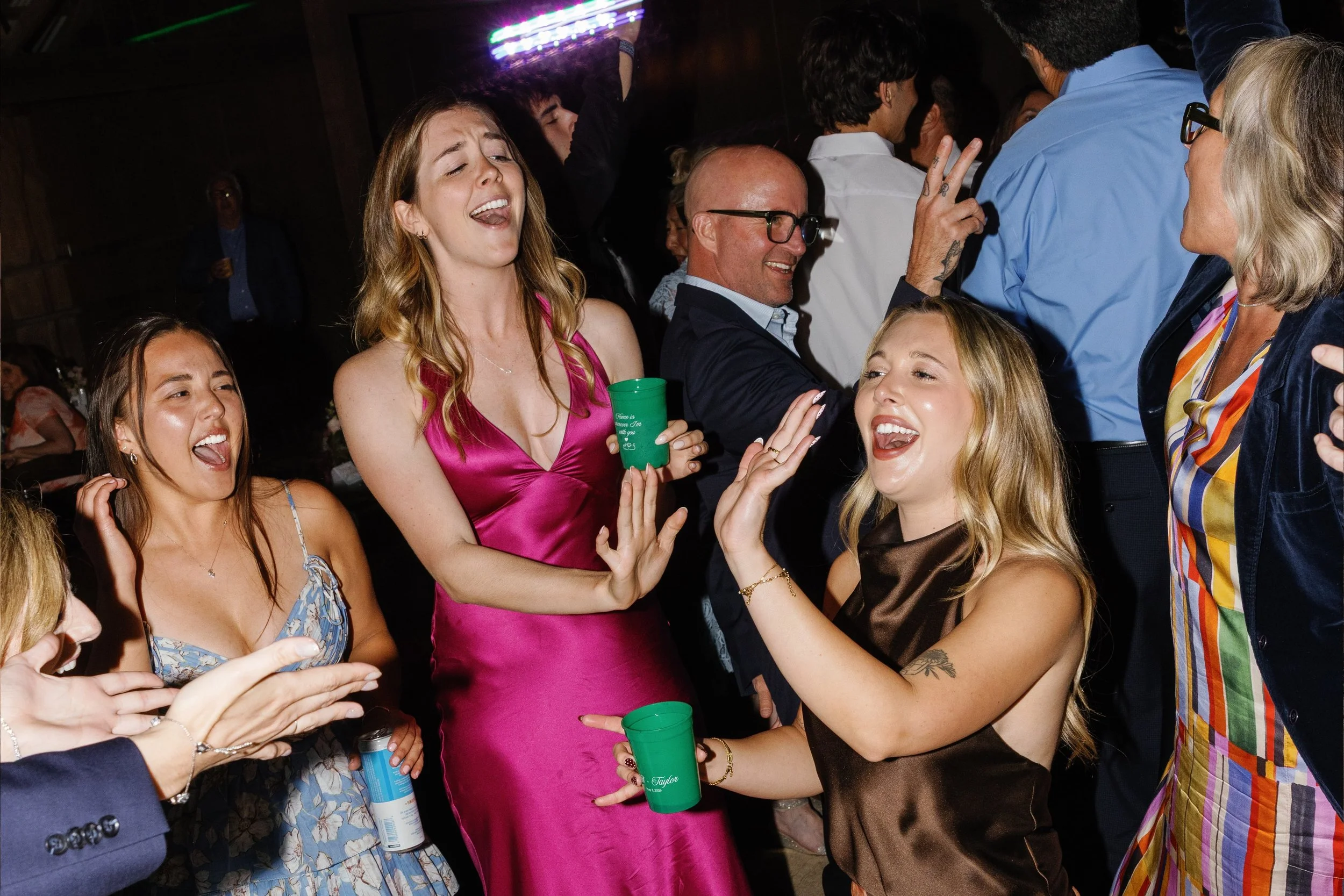 Photo Credit: Kaitie Brainerd, The White Barn, San Luis Obispo Wedding (Several of a couple's friends and family dance together. Many people are singing along to the song and showing off their dance moves!)