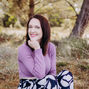 a celebrant woman wearing purple and smiling