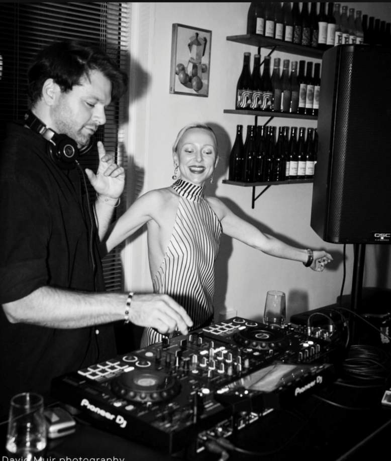 Girl Juliette, Tasmanian wedding singer, dancing beside a DJ mixing on Pioneer decks