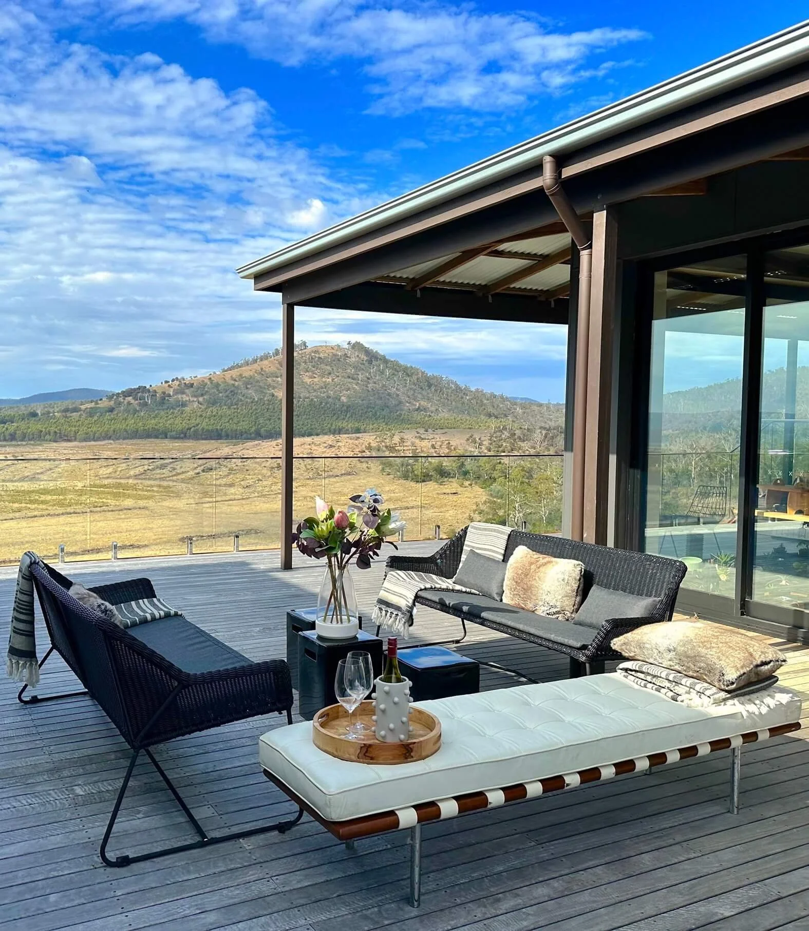 Outdoor deck lounge with mountain views at Sherwood Loves Tasmania, Buckland, East Coast