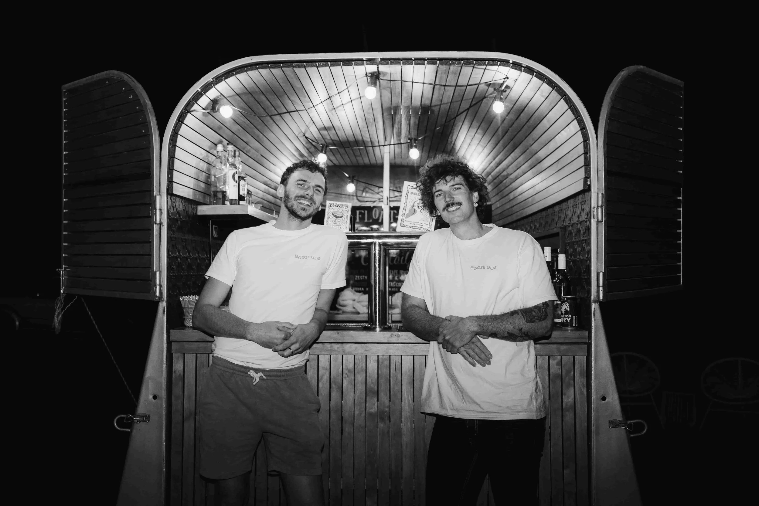 horse float bar with bartenders in white tees standing at bar