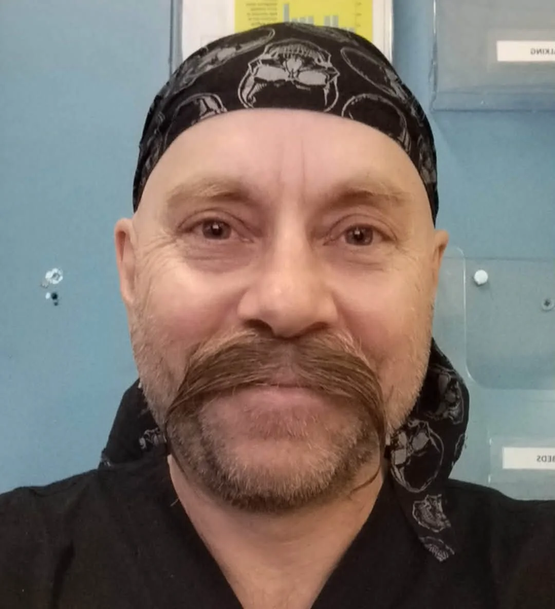 a close up facial image of a celebrant man