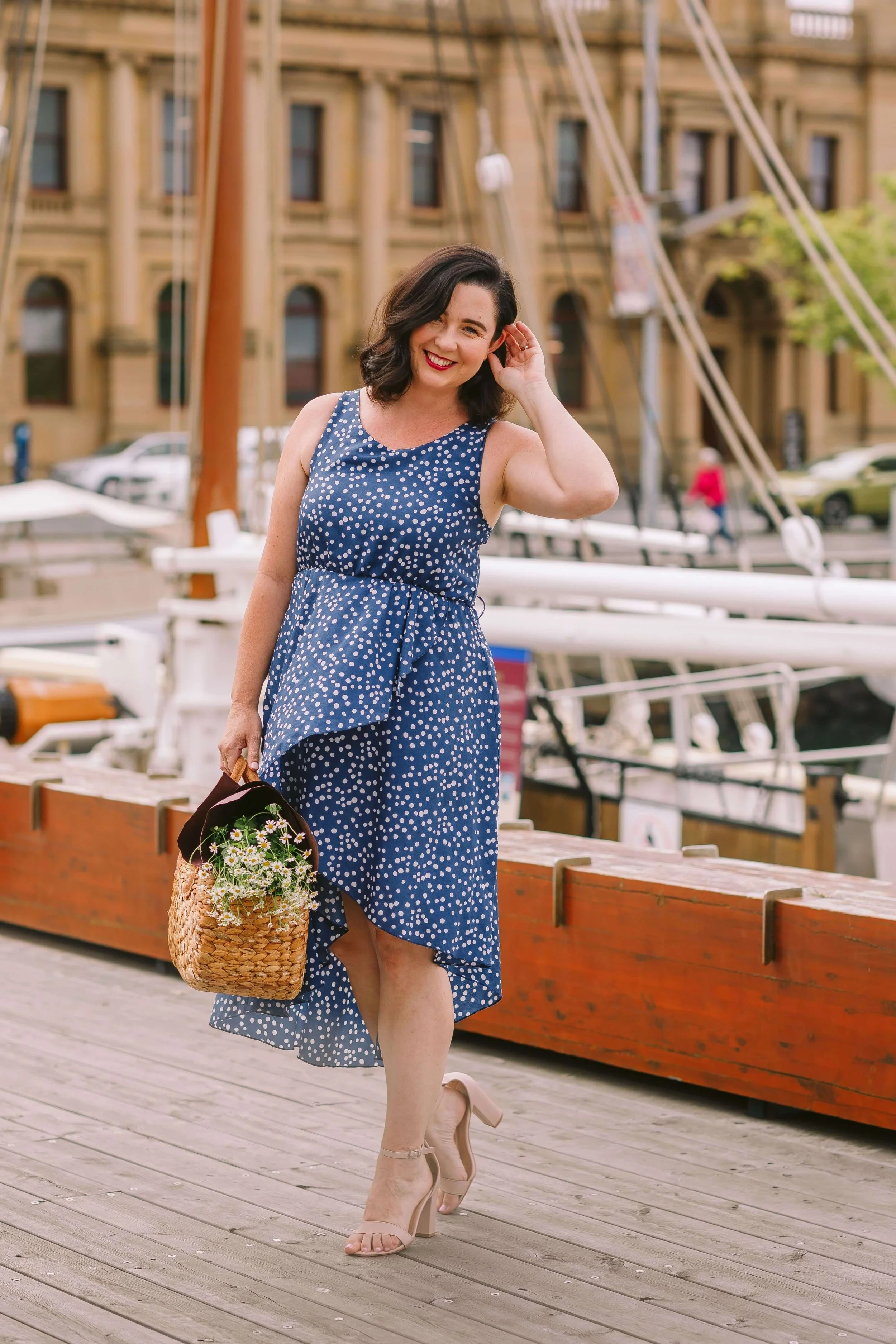 celebrant wearing blue dress carrying bag on Hobart waterfront