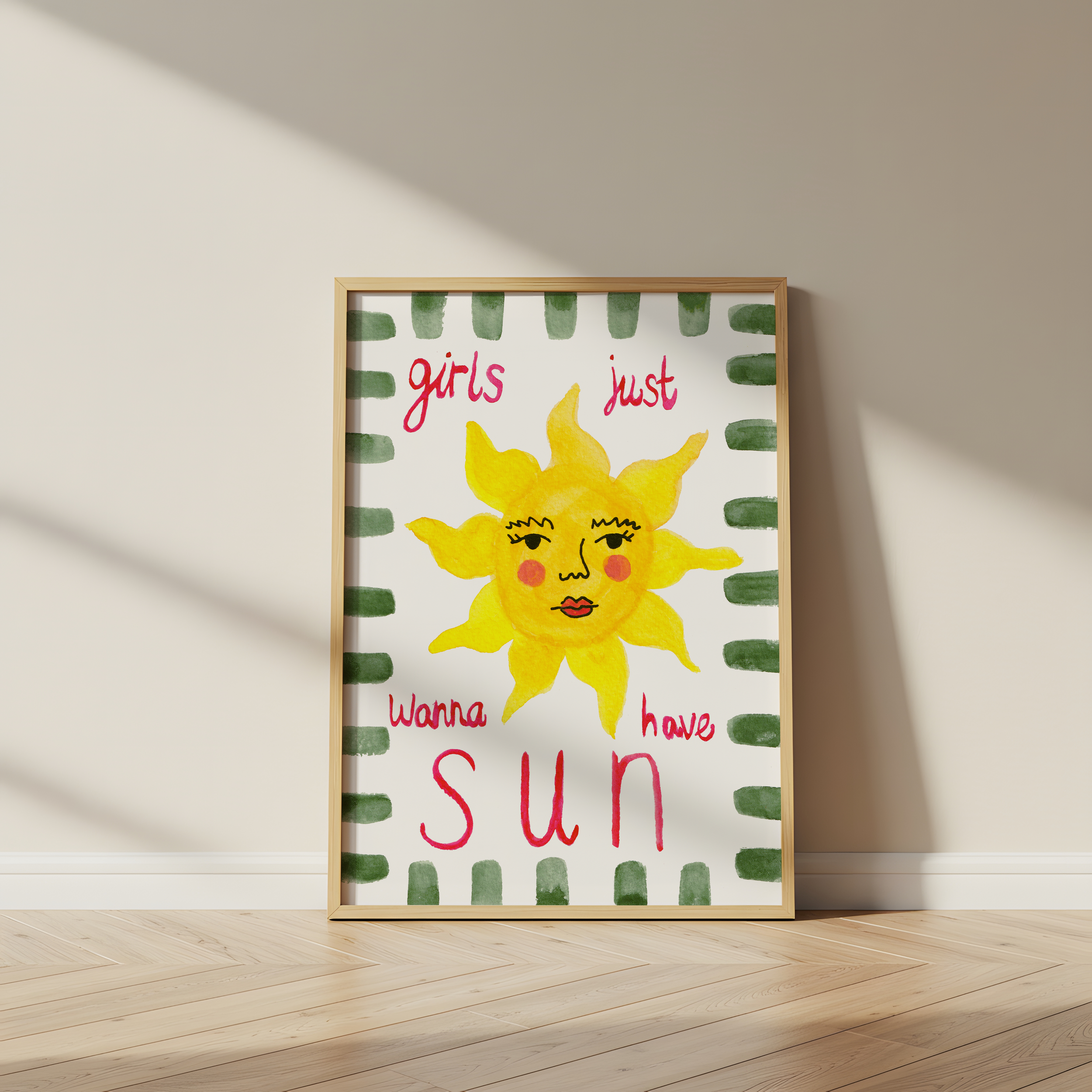 Colorful art print featuring a smiling yellow sun with a female face, surrounded by a green striped border, with pink handwritten text that says 'girls just wanna have sun'.