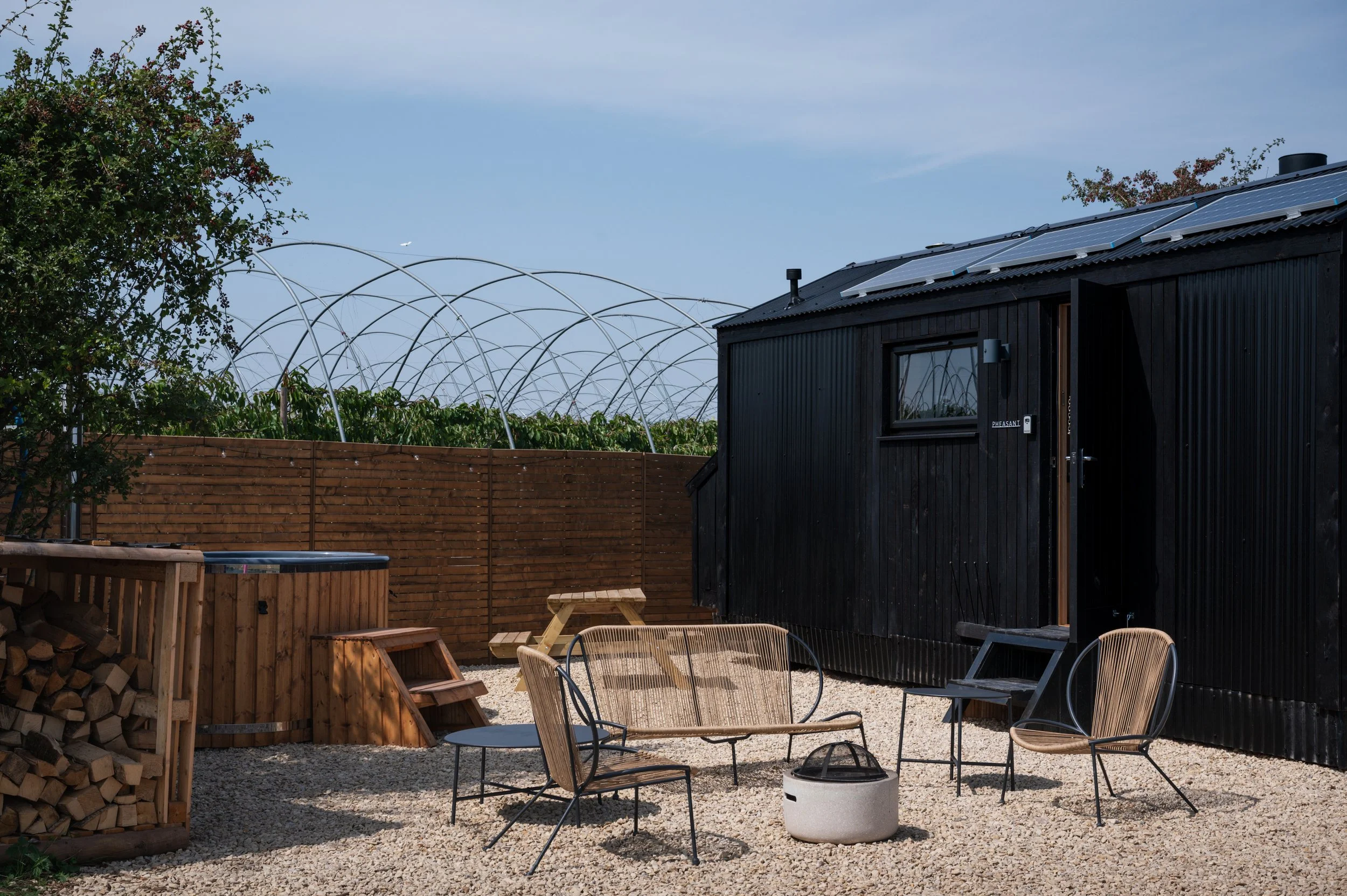 Eco-friendly black-clad tiny house with solar panels.