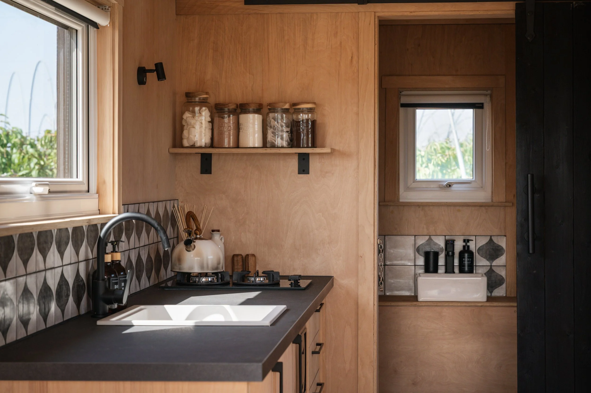 A handcrafted tiny home showcasing traditional design with a modern twist. This completed off grid cabin is perfect for simple, sustainable living.