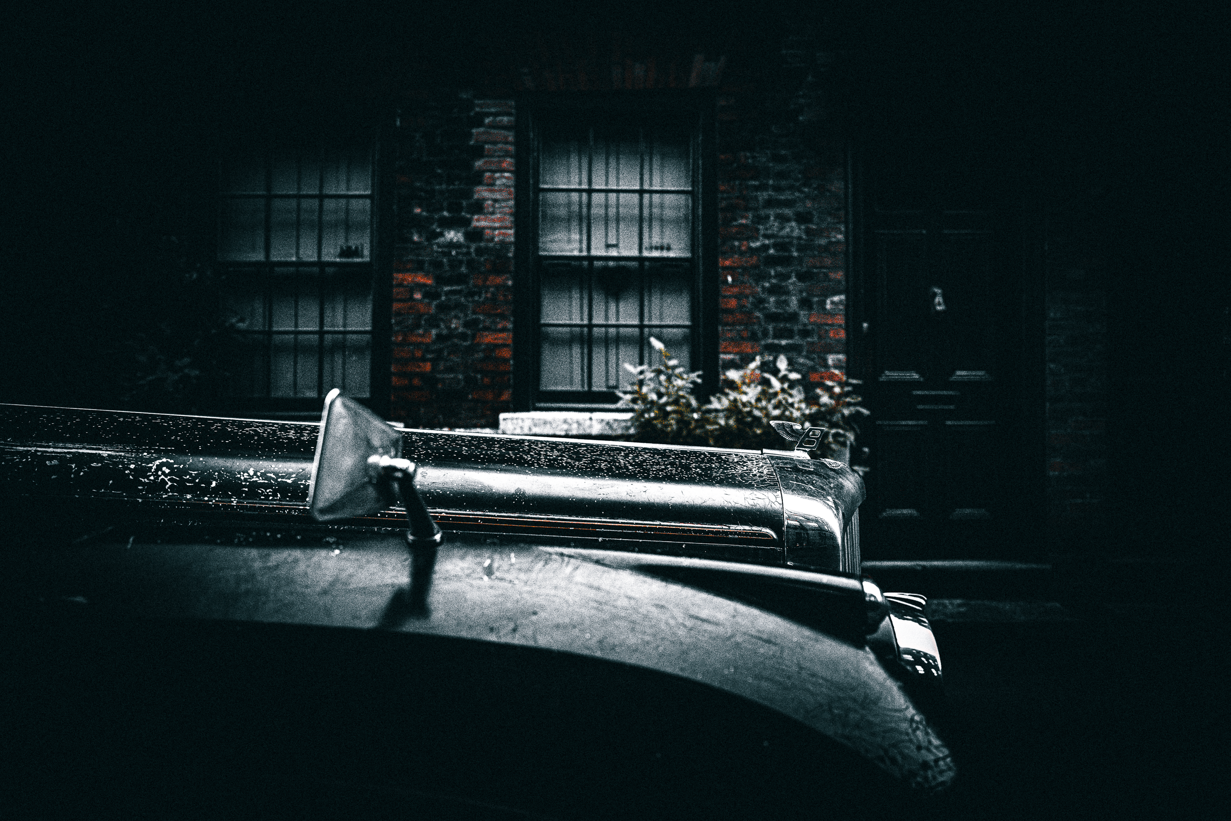 Outside Elegance. Parked with poise, the Bentley waits, its elegance undimmed by shadow or silence.