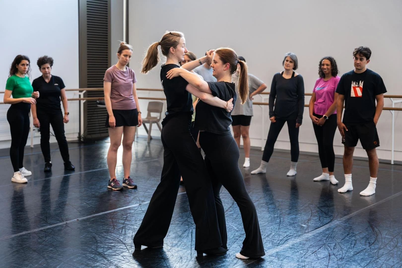 2 women dancing together in a Ballroom class