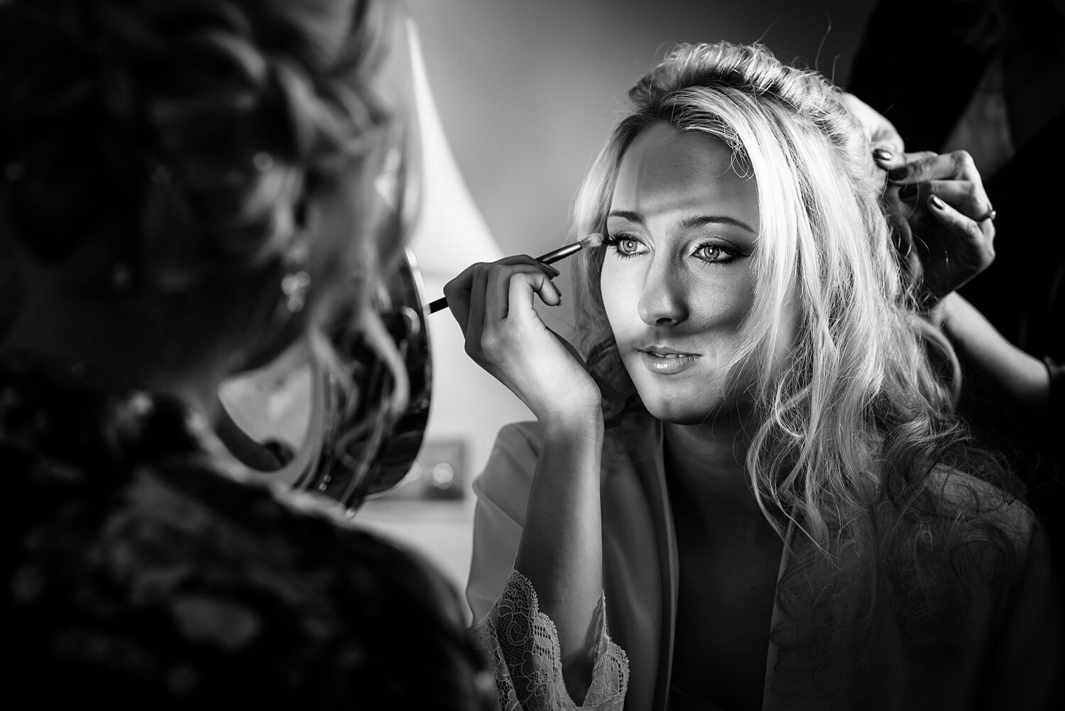 Bride doing her makeup at Peterstone Court wedding.