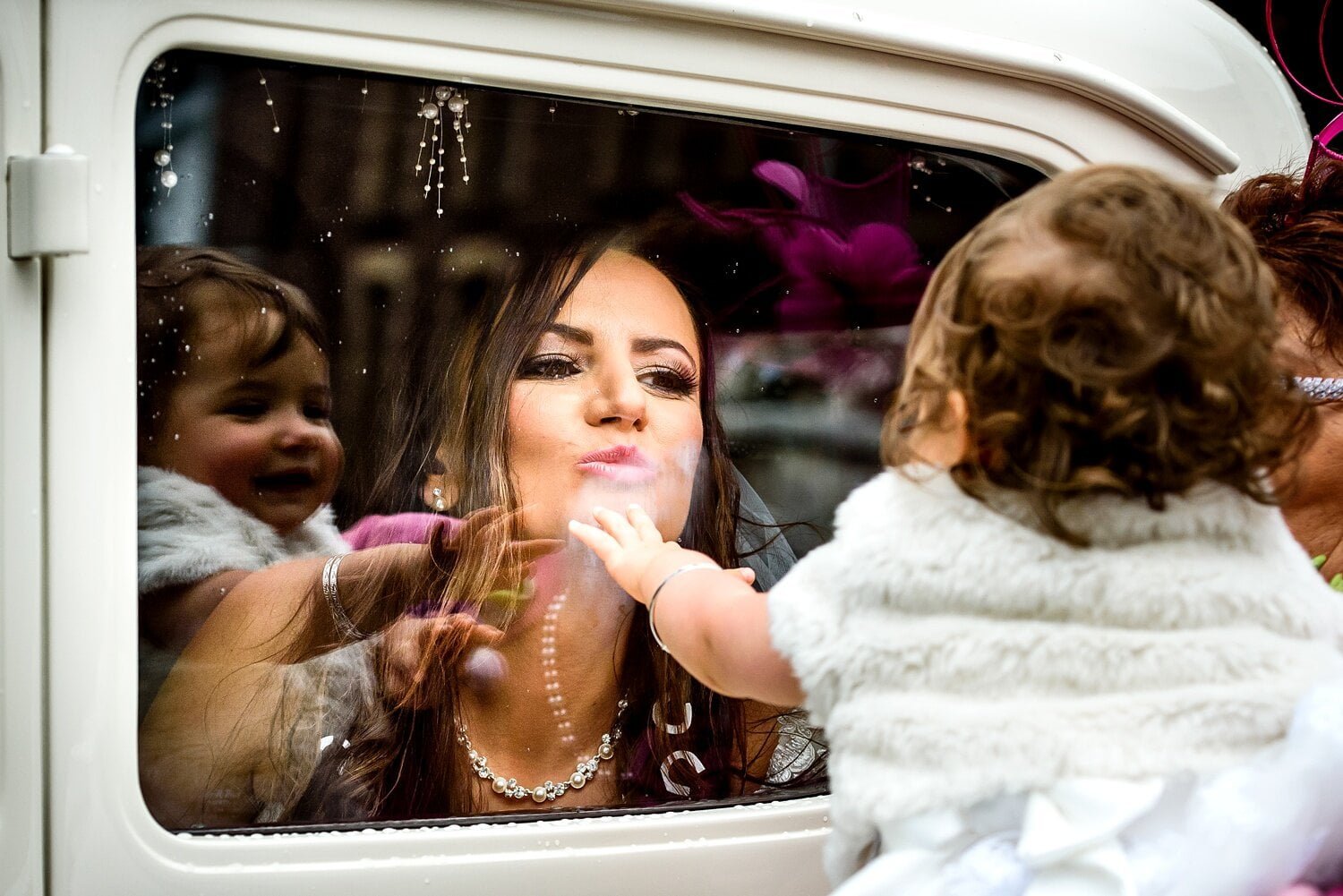 Bride blows a kiss to the flower girl at Carmarthenshire wedding photography by Rich Williams of Real and Rich Photography, a South Wales based Wedding Photographer.