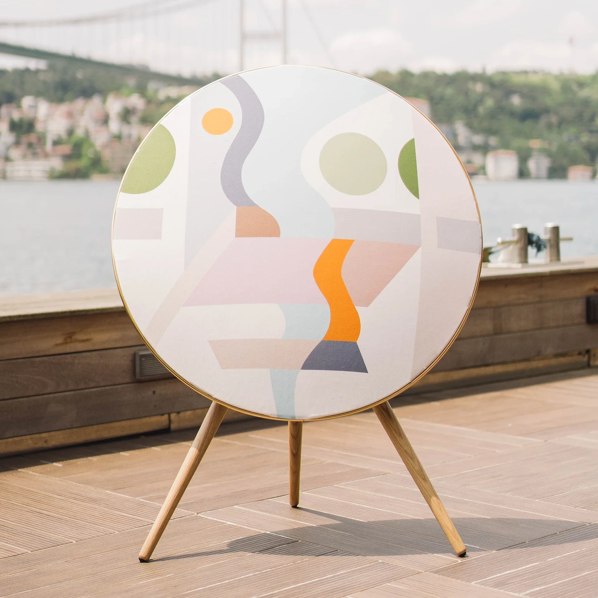 Wireless speaker with sculptural circular form and acoustically calibrated fabric.