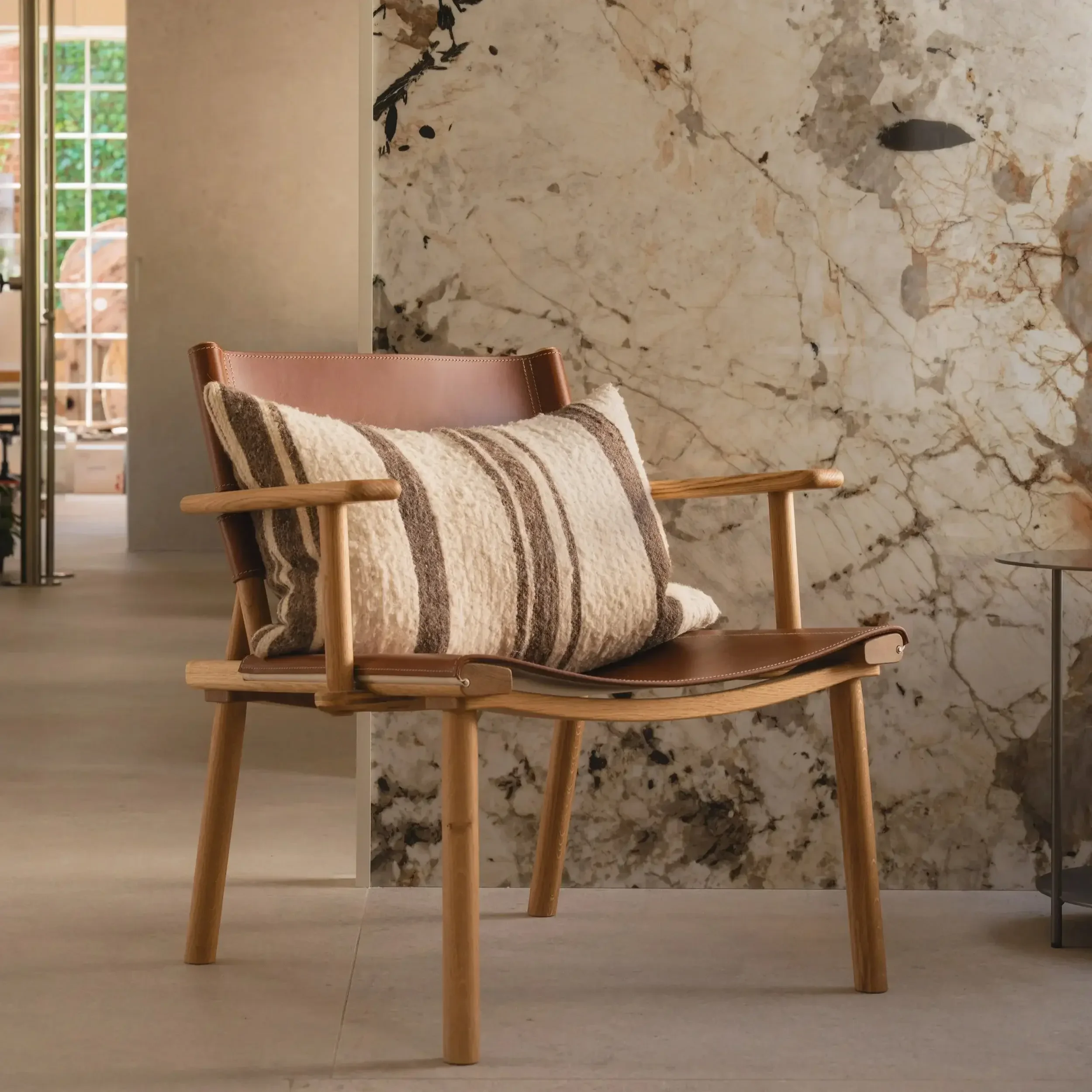 December Lounge Chair by Nikari in oiled ash with linen upholstery in a modern living room.