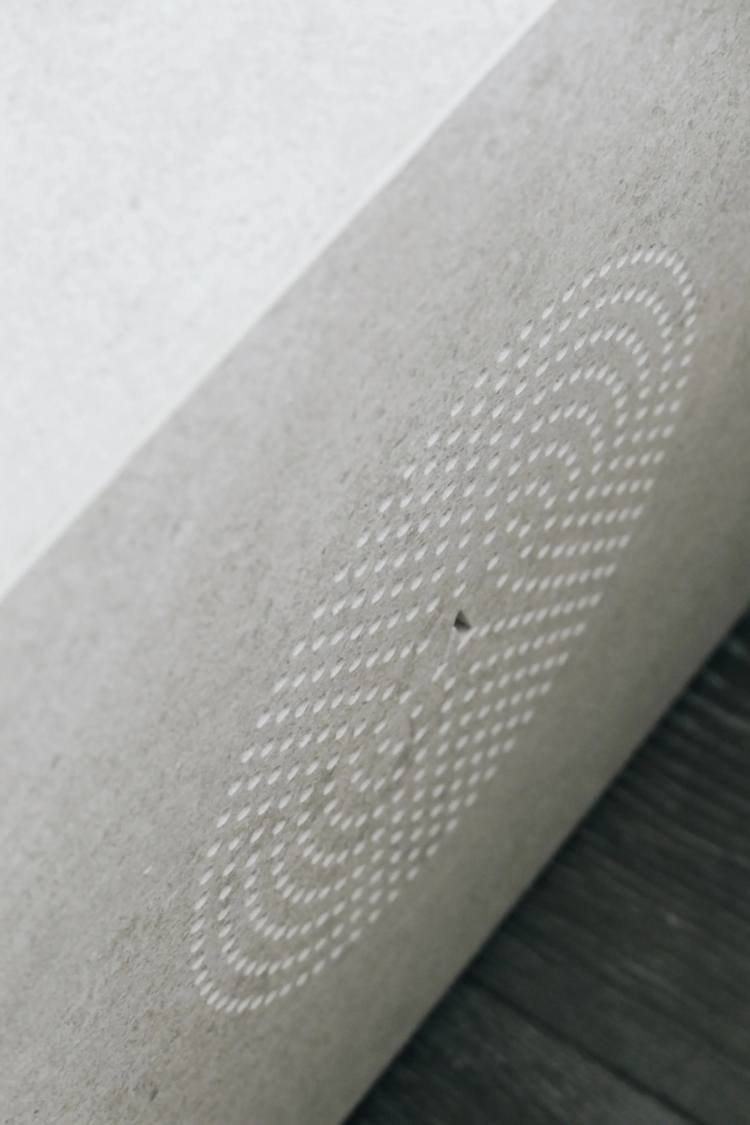 Detail of high-end Italian porcelain tile with custom CNC-cut textures, showcasing luxury surface design in a Dorset interior renovation.