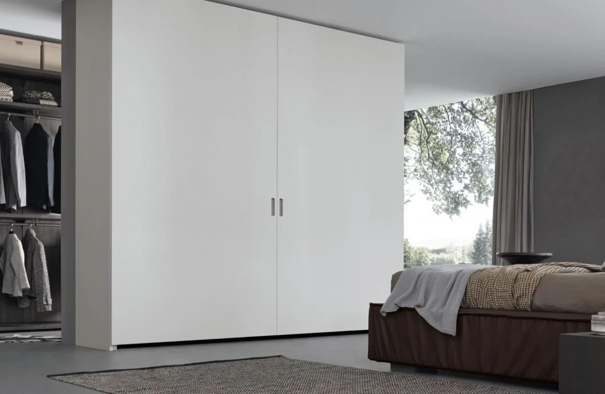 Coplanar Pacific Wardrobe by Giellesse with coplanar sliding doors and minimalist design in contemporary bedroom.