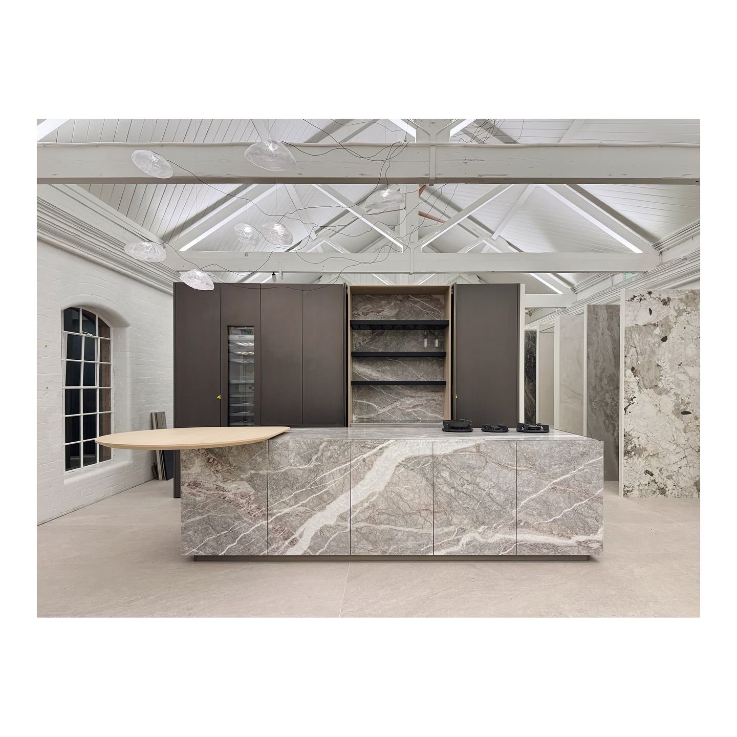 The movement of the marble is echoed by the movement of the Bocci sculptural light. The connection of the LEDs within the pocket door recess will bring this display to completion, ready to dress.

This week also sees another Zampieri Segni being inst