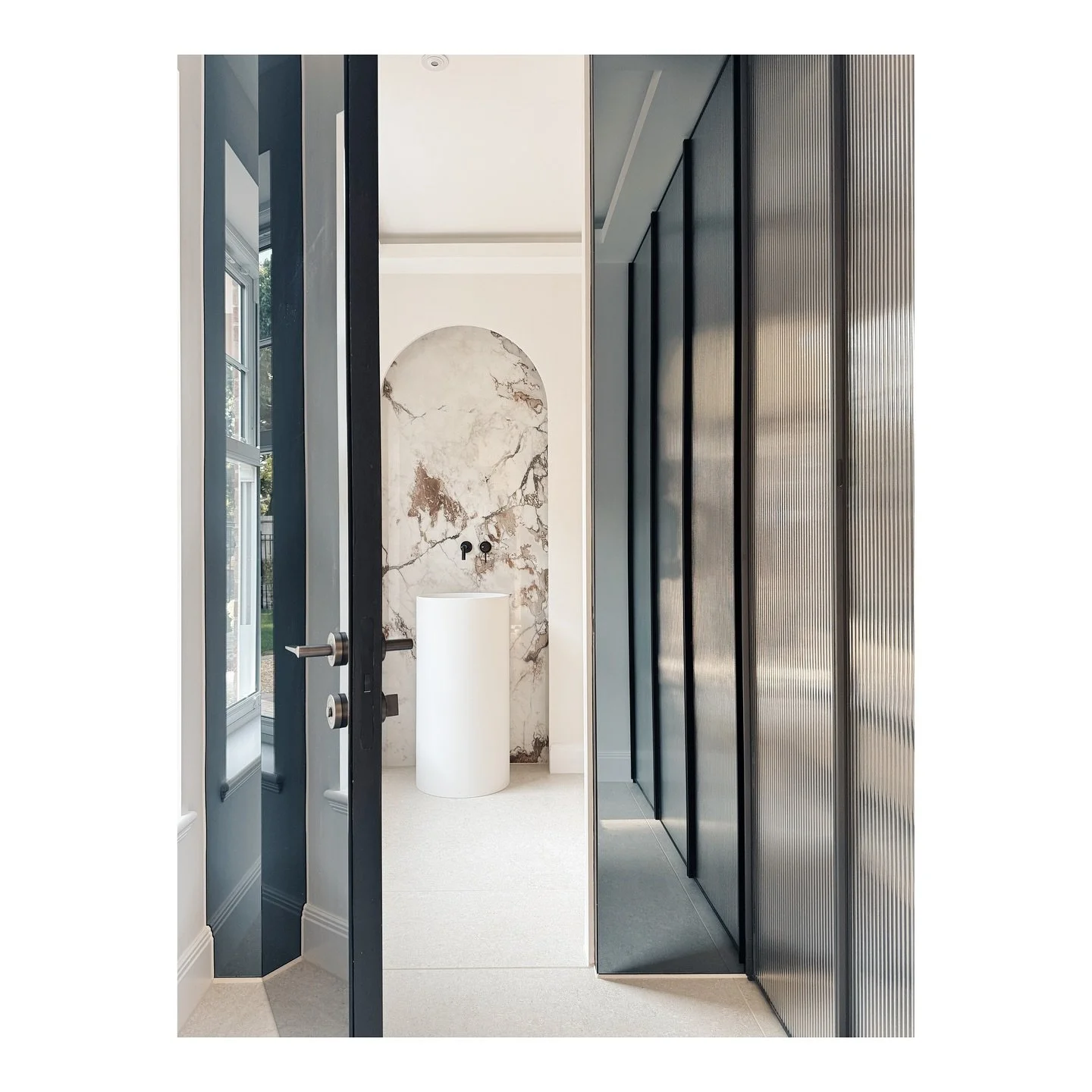 Cloakroom and WC at Glenferness. Two of our favourite details are the freestanding washbasin framed by the large format Breccia marble and the fluted glass wardrobes, with leather tray insets. What do you think?

#interiordesign #interiorarchitecture