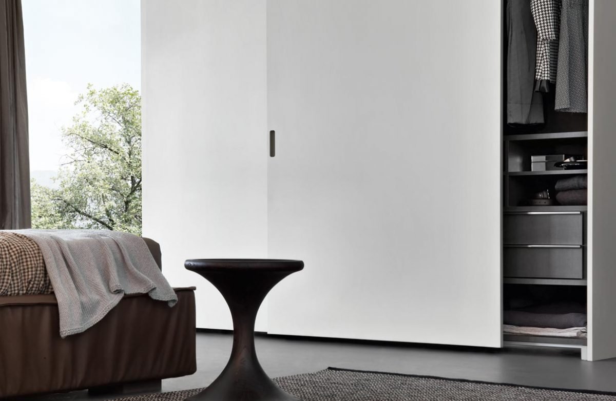 Minimal bedroom interior featuring the Pacific coplanar wardrobe by Giellesse.
