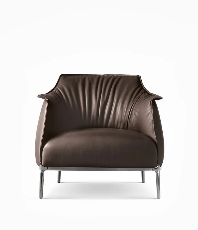 Poltrona Frau brown leather armchair with curved back and slim metal legs, available through Abitalia South Coast in Dorset, Hampshire, Surrey, UK.