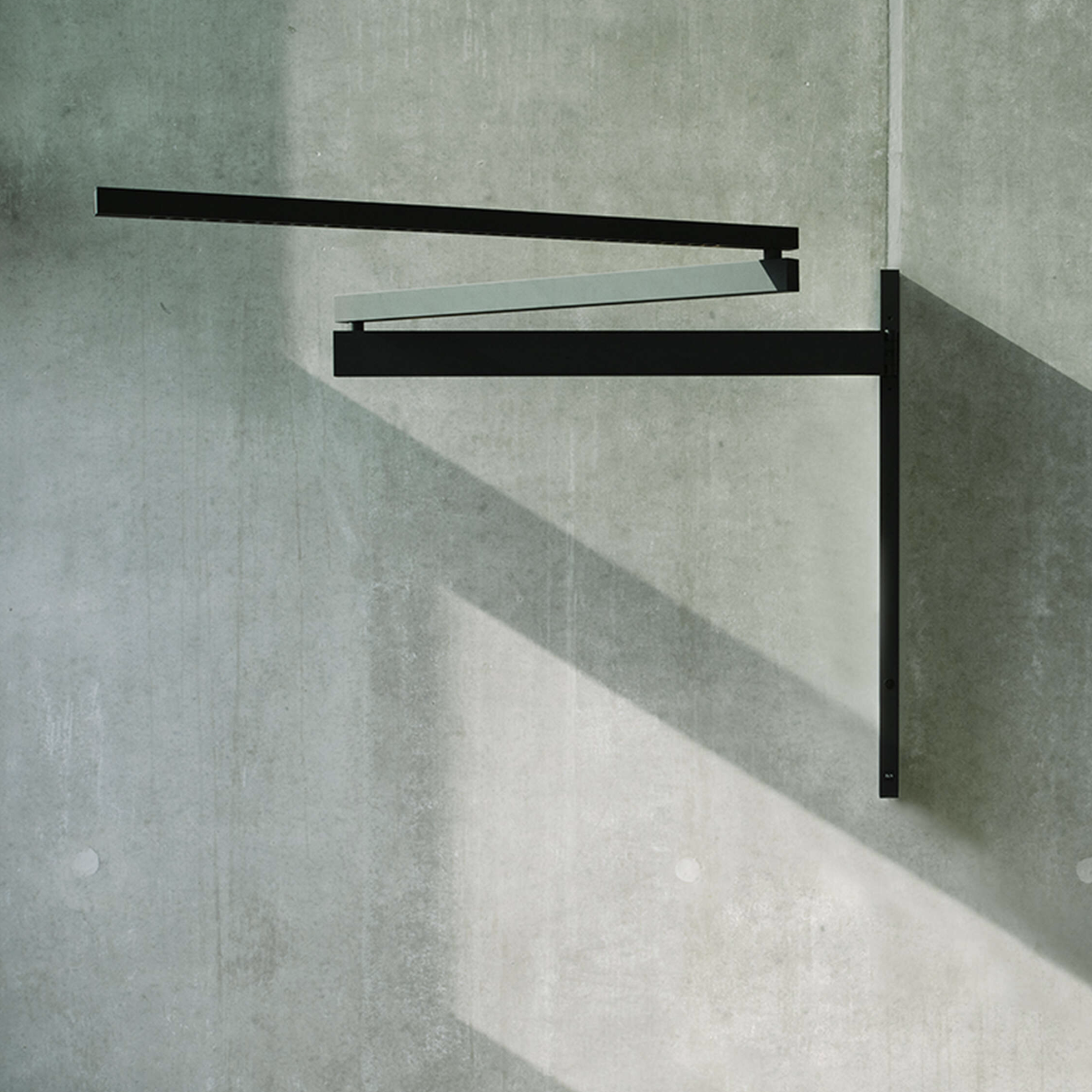Flos Black Flag wall light mounted with adjustable arm and minimalist design.