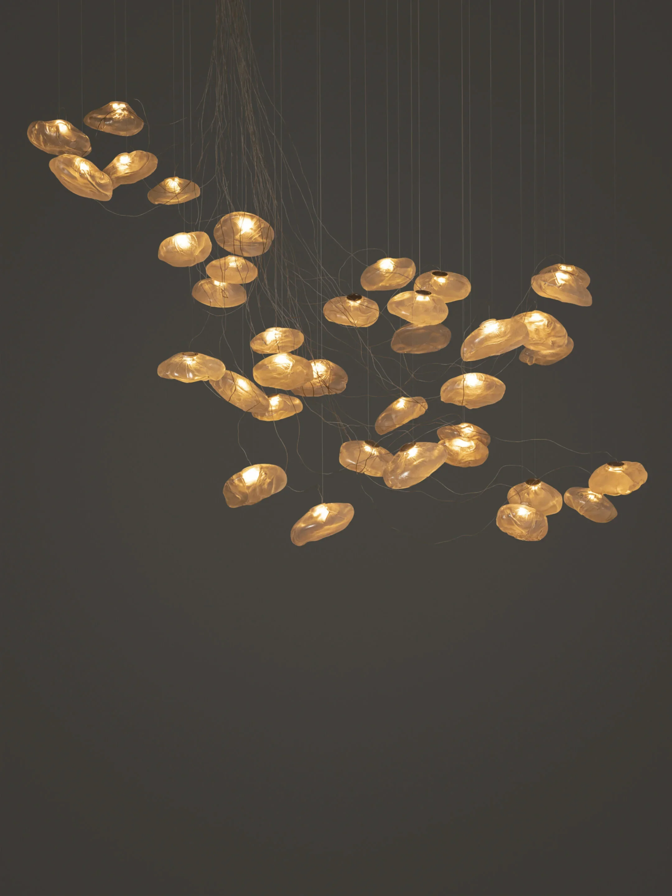 Multiple pendant lights arranged at varying heights, showing the modular flexibility of the 73 Series.