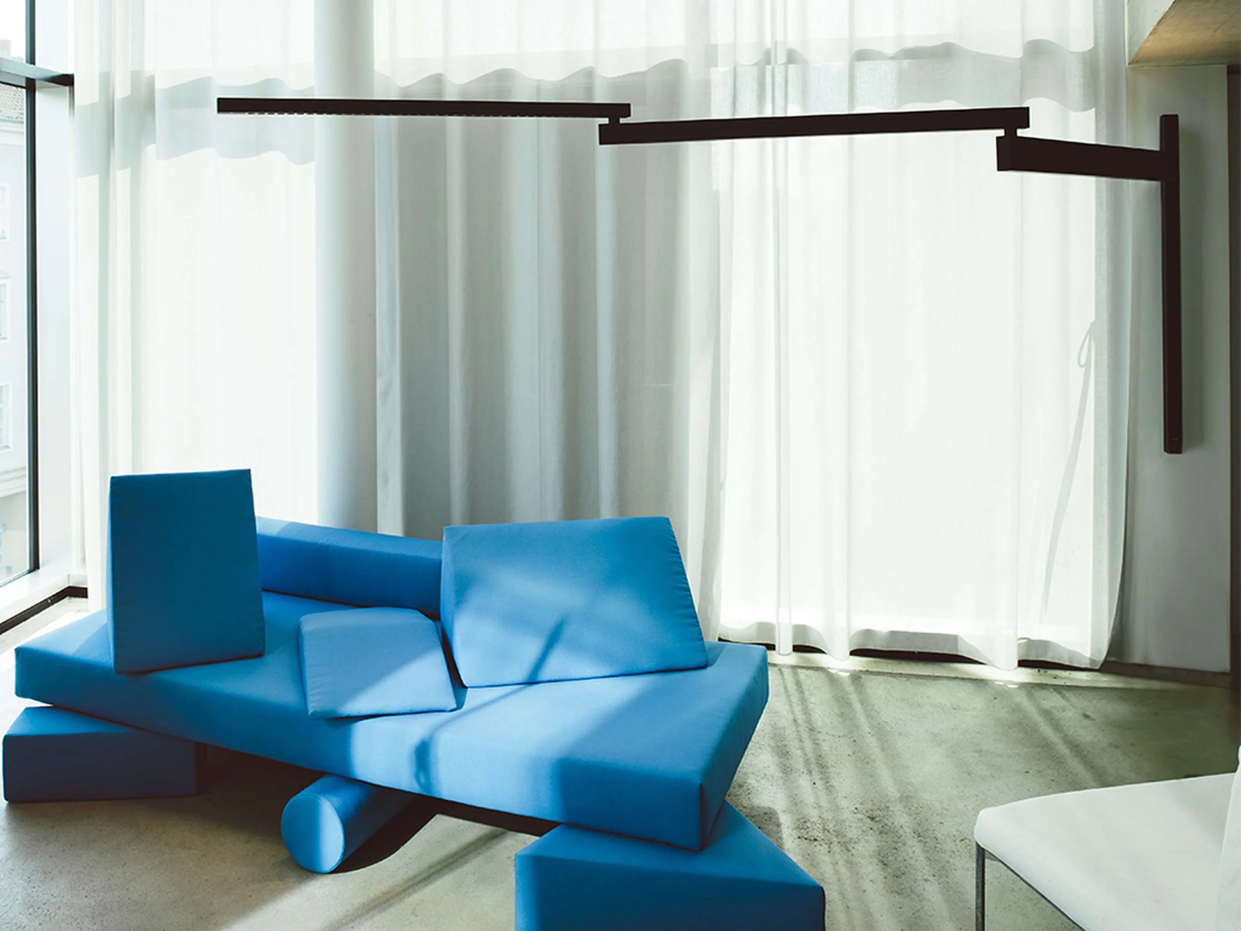 High-end designer wall light combining technical innovation and expressive form.
