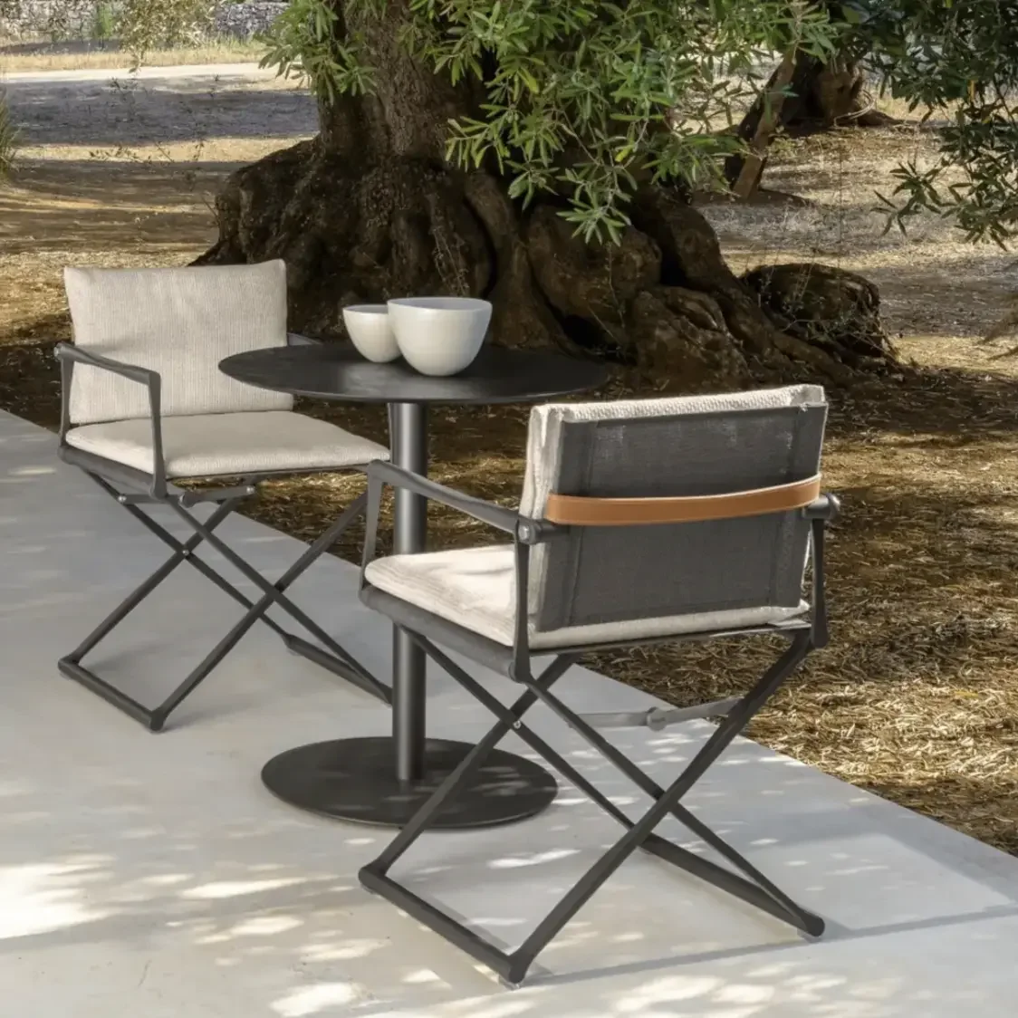 Riviera lounge armchair by Talenti displayed in an outdoor setting, highlighting its sculpted aluminium frame and relaxed, contemporary silhouette. Serving across New Forest.