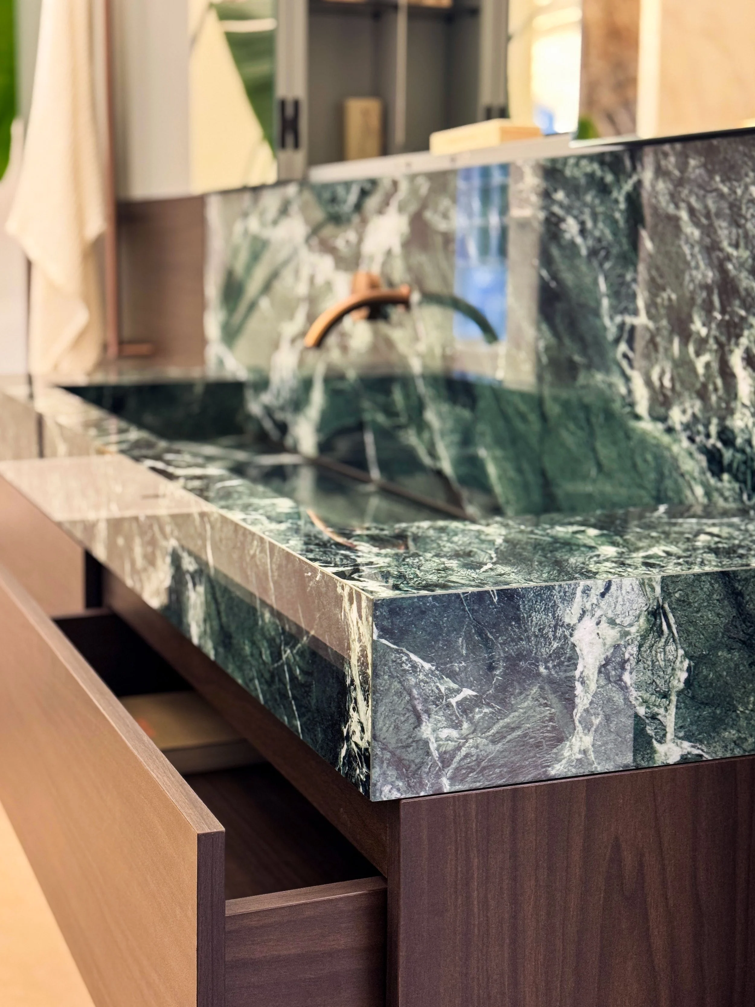 Integration of the sink and drawer, emphasizing seamless interaction of materials and finishes.