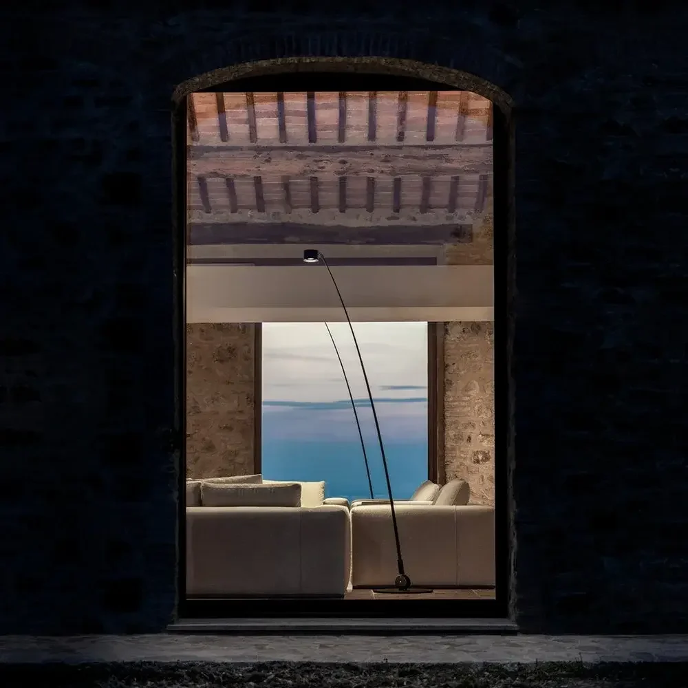 Davide Groppi Sampei Outdoor Floor Lamp featuring a slender arching stem inspired by a fishing rod, supplied by Abitalia South Coast in Dorset, Hampshire, and Surrey.