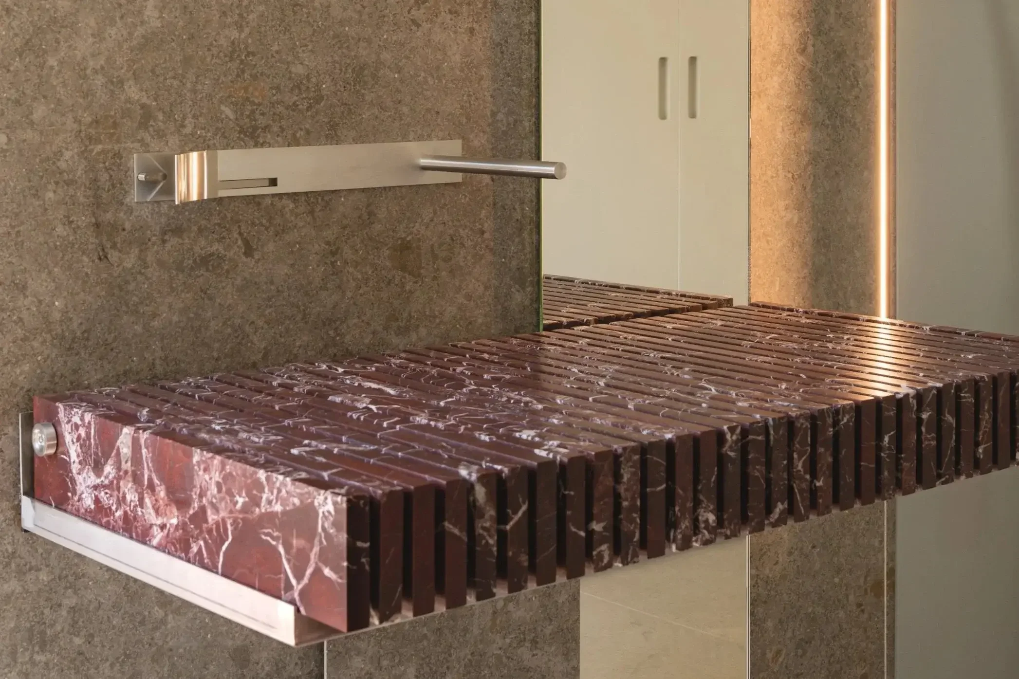 Piano Sink by Serafini with vertical marble slabs and floating minimalist design in modern bathroom.