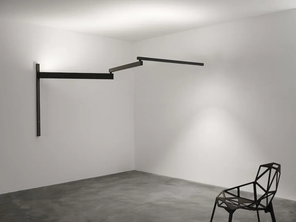 Modern wall lamp with an adjustable arm reaching up to 3.5 metres for flexible lighting.